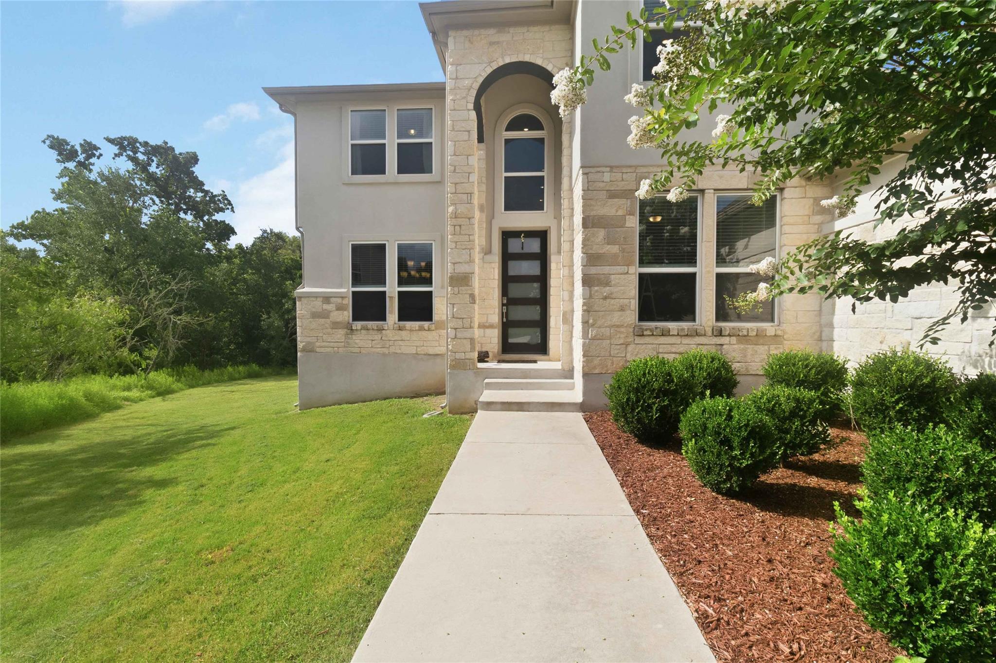 A striking modern facade with stone accents and a