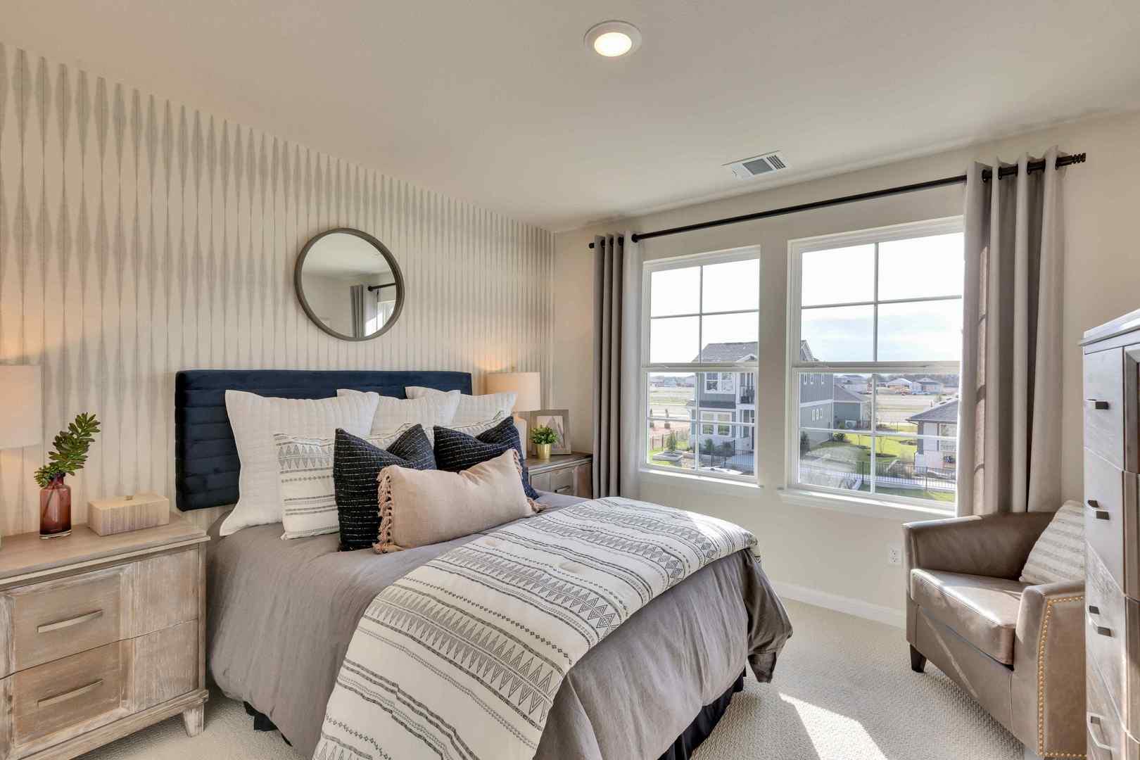 Well-lit and tranquil, this bedroom provides a pe