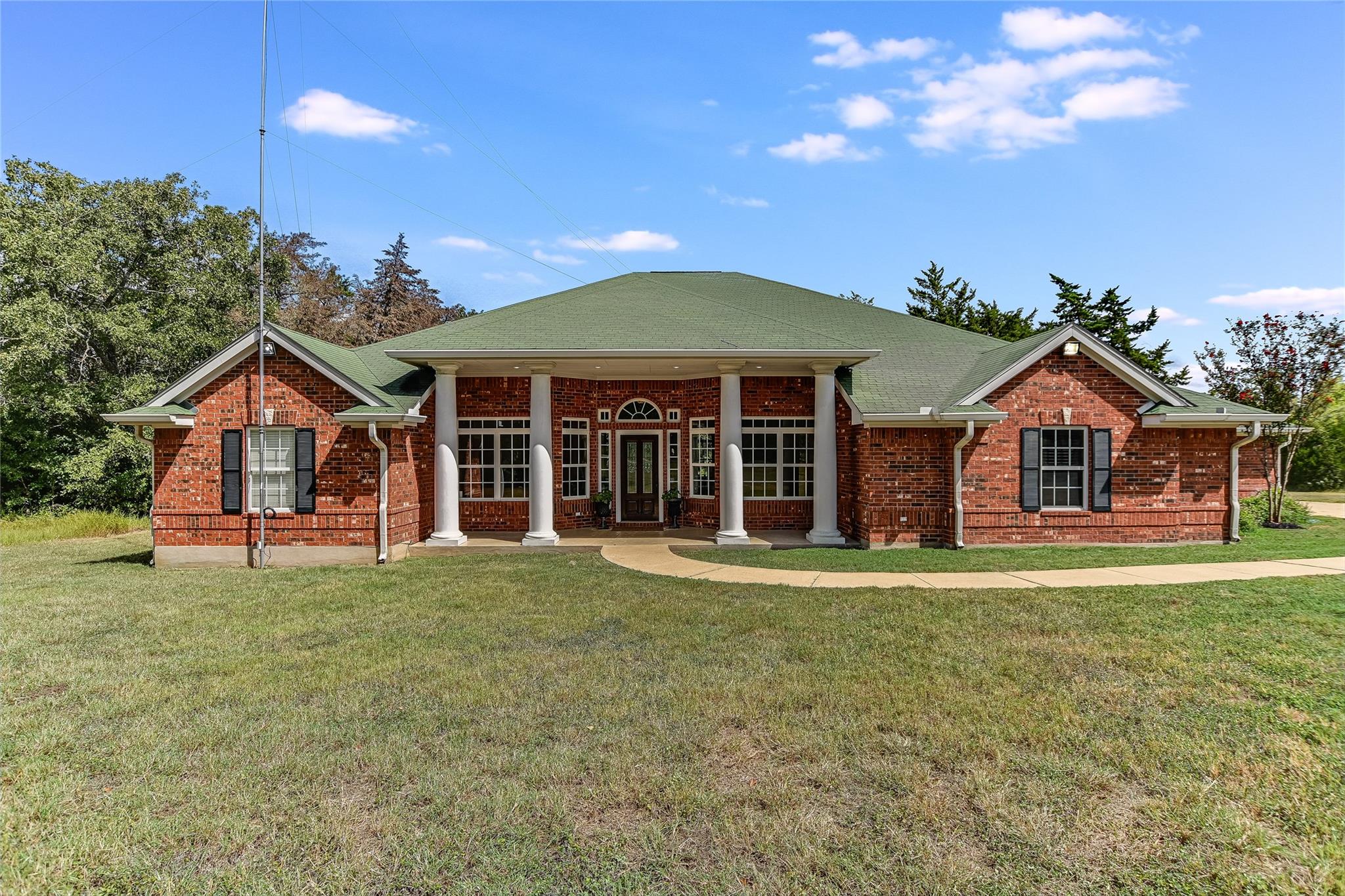 A classic brick exterior with a welcoming columne
