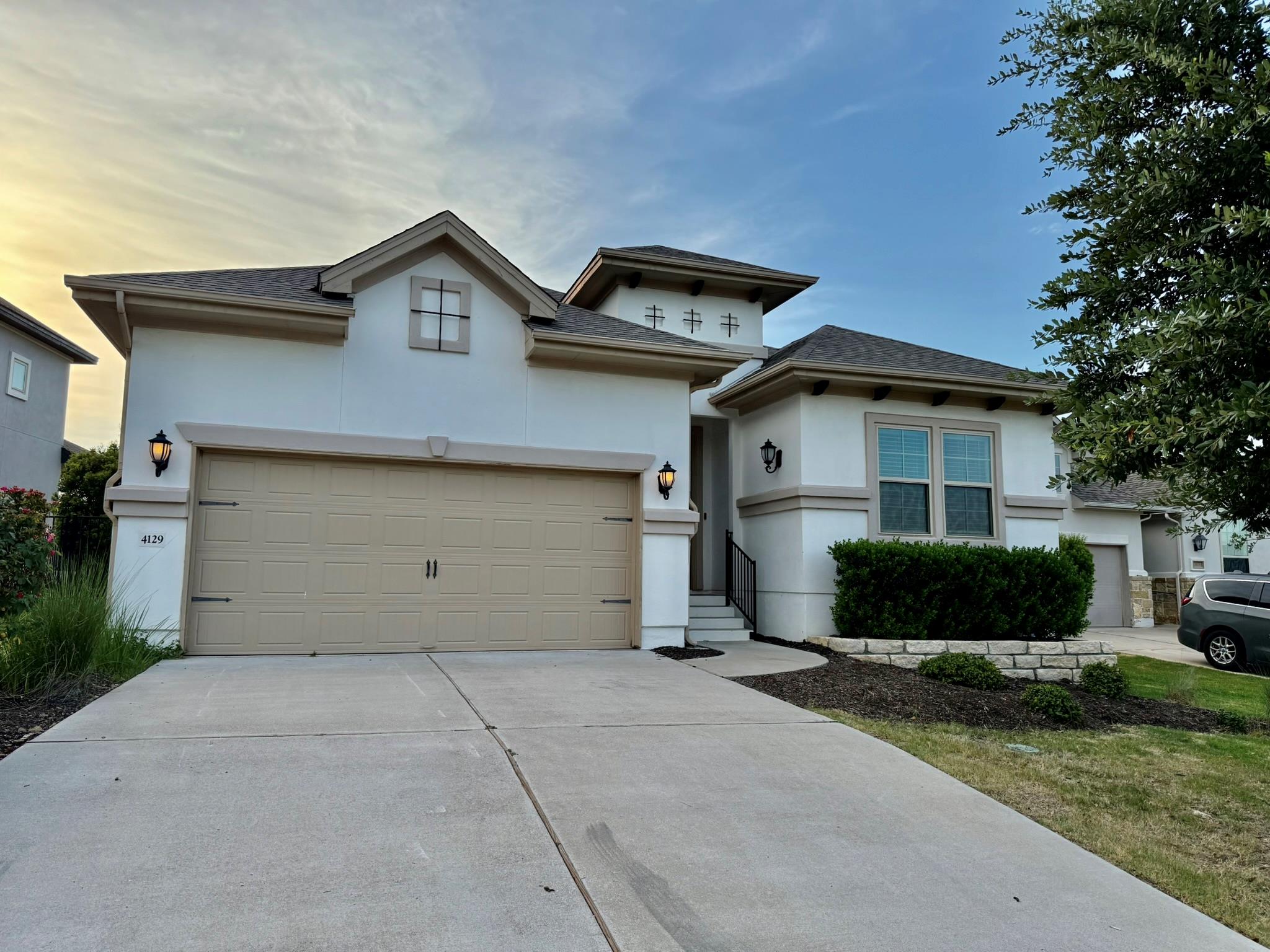 A well-kept front exterior with a wide driveway a