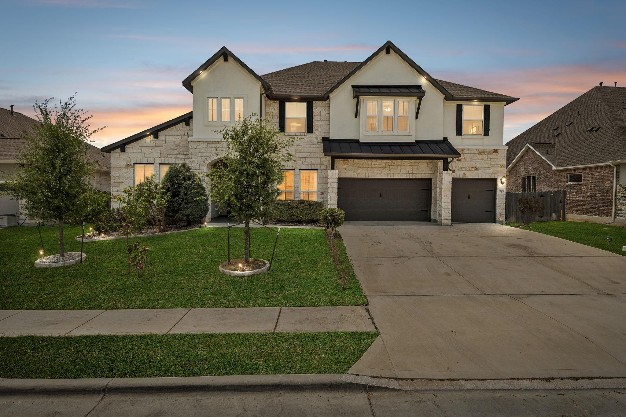 A well-maintained lawn and extended driveway enha