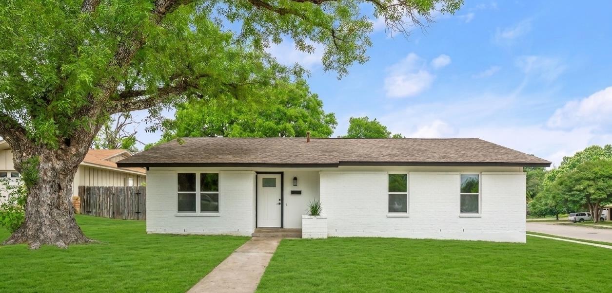A classic ranch home, freshly painted white, nest