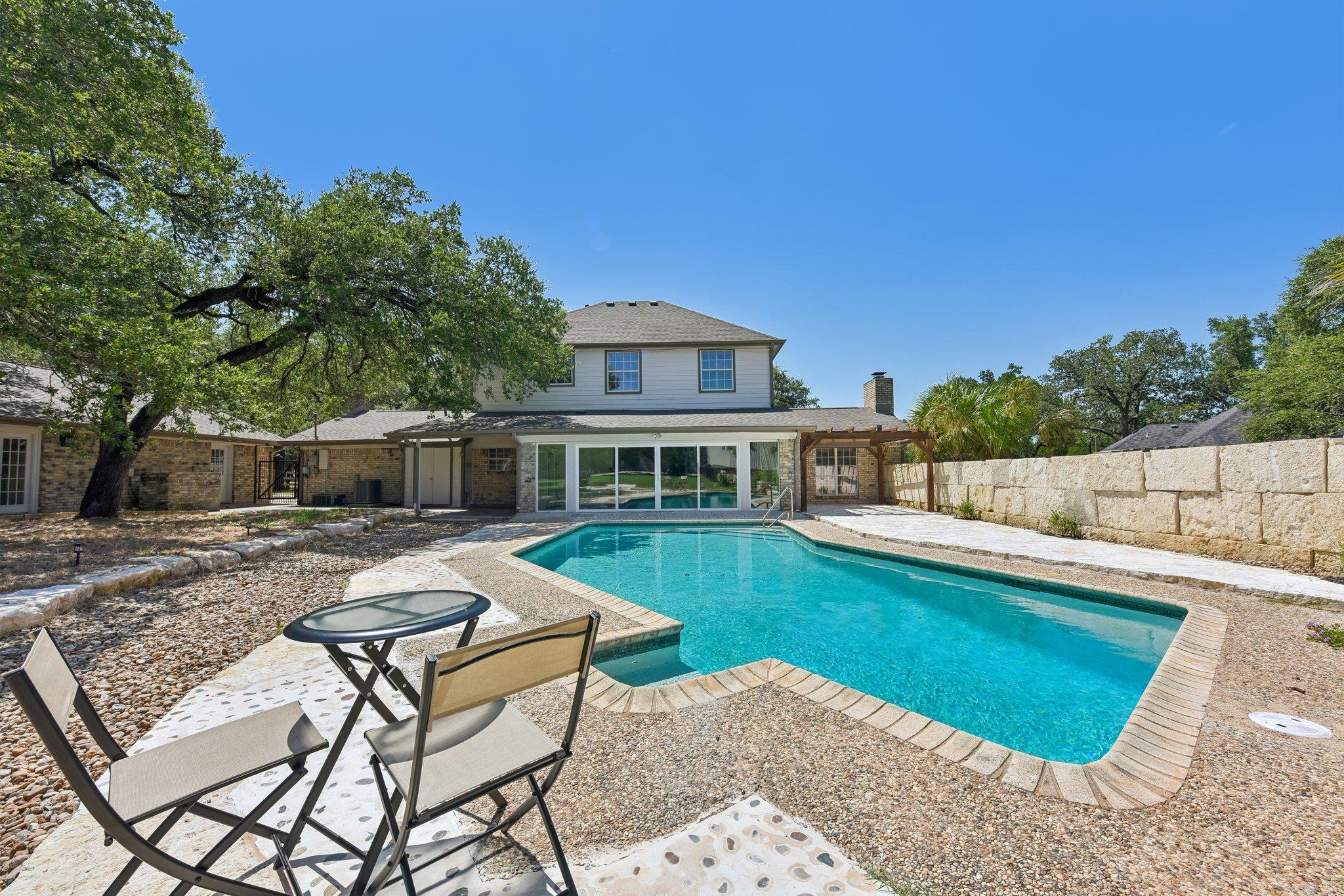 An inviting backyard oasis features a shimmering 