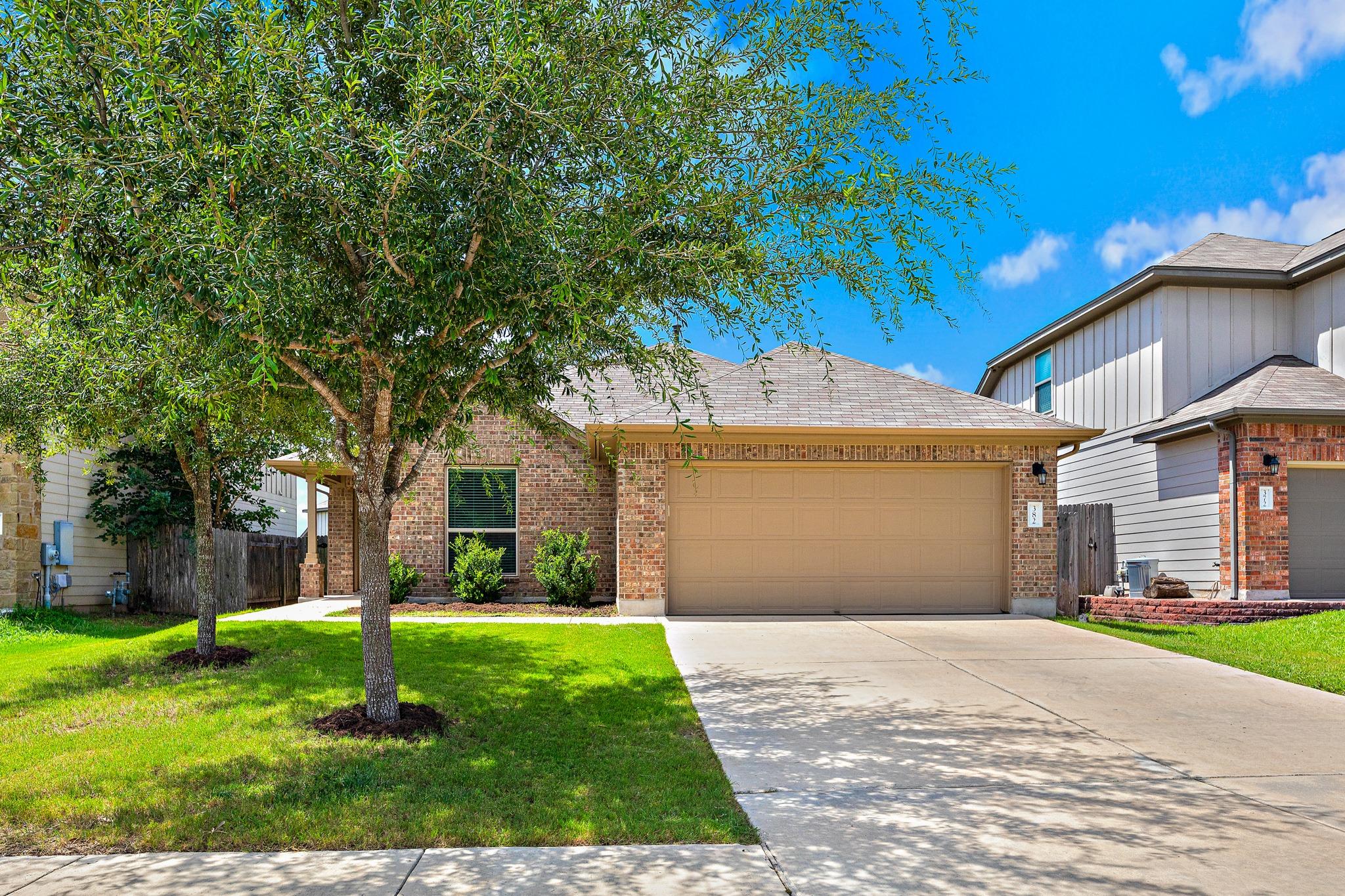 A classic brick exterior with an attached garage 