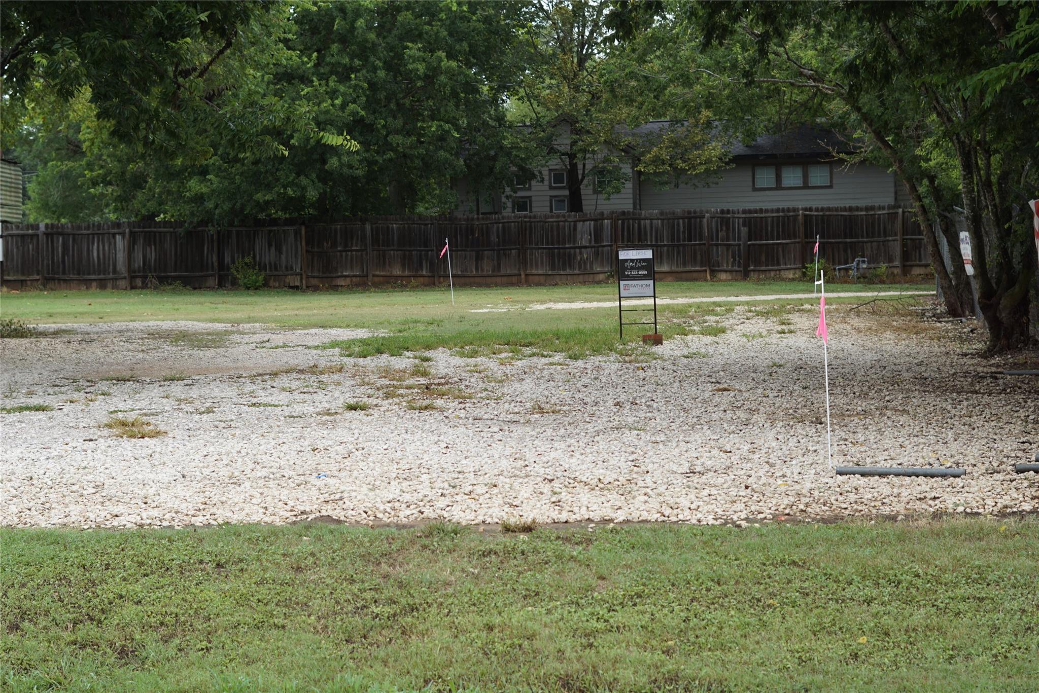 A spacious, buildable lot awaits your vision, fea