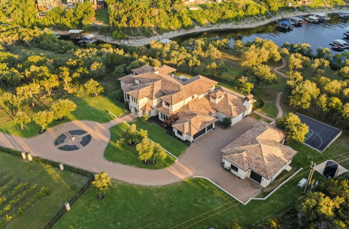 An opulent estate features a circular driveway an