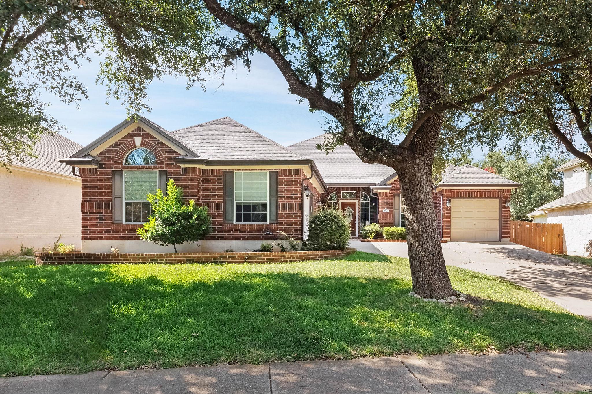 A classic brick exterior with a well-manicured la