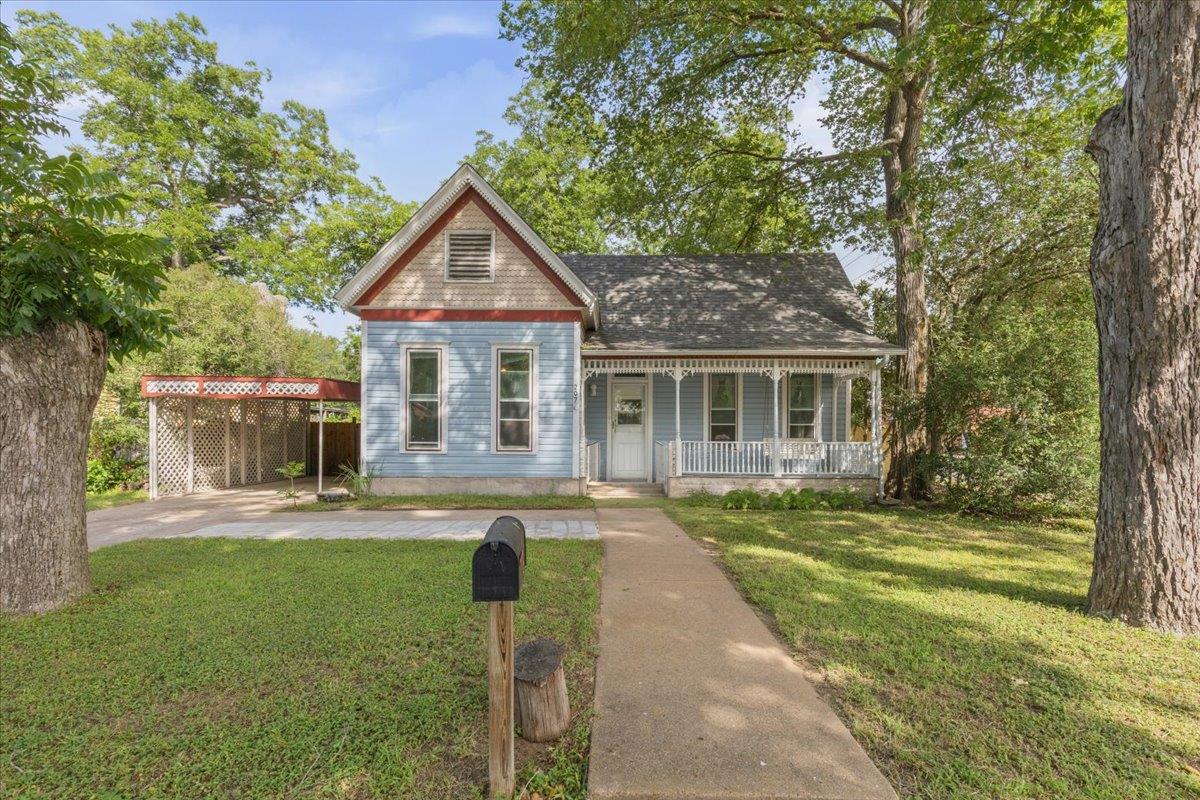 An inviting front porch welcomes you to this clas