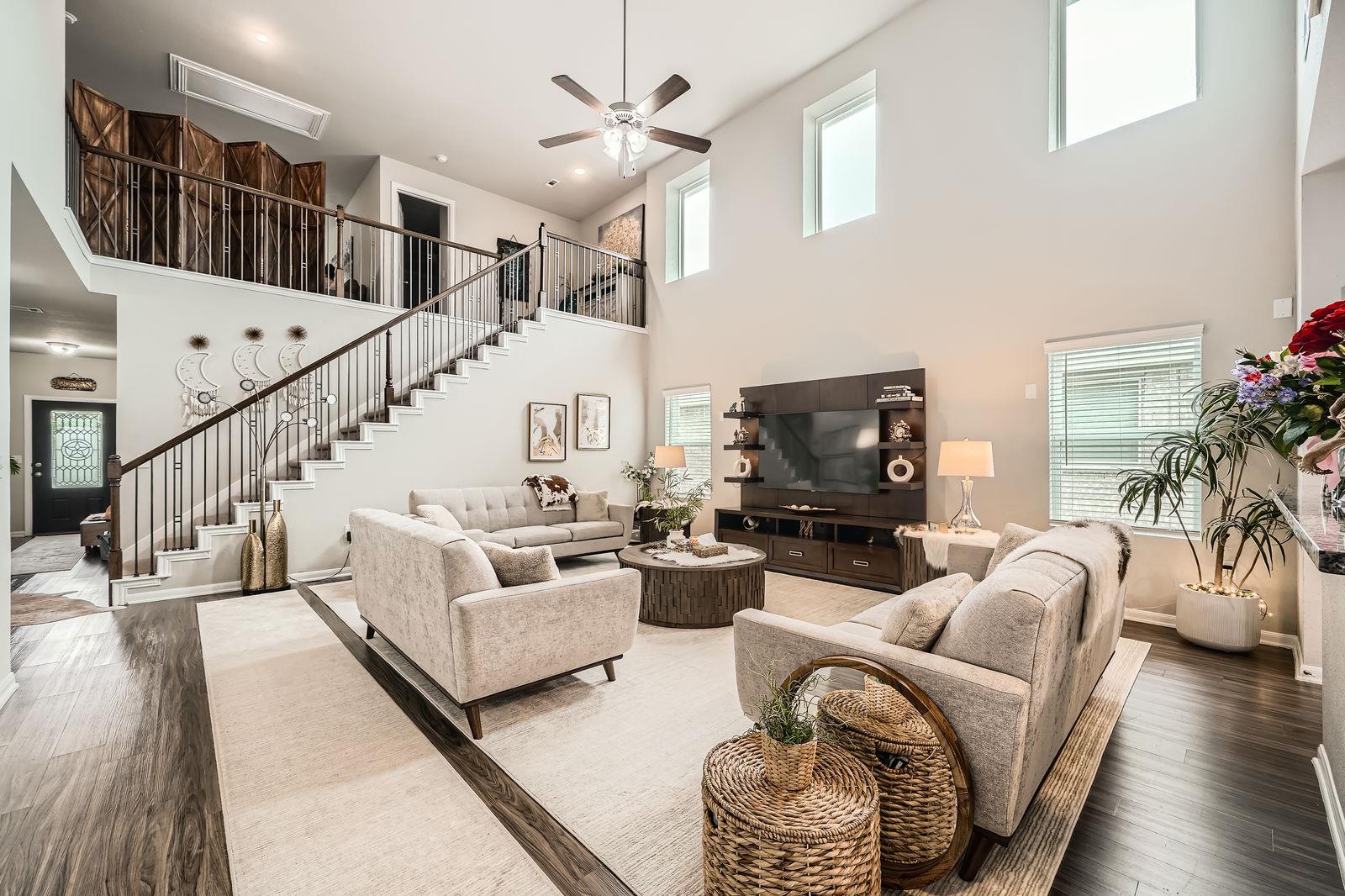 Living area with a high ceiling, wood finished fl