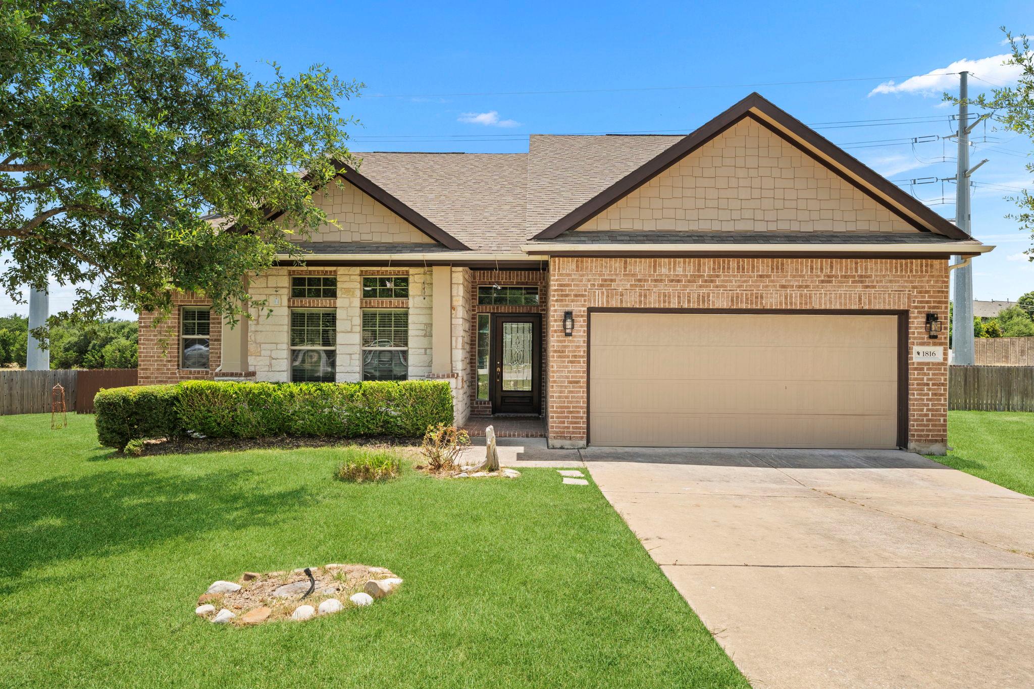 A neatly maintained lawn complements the charming