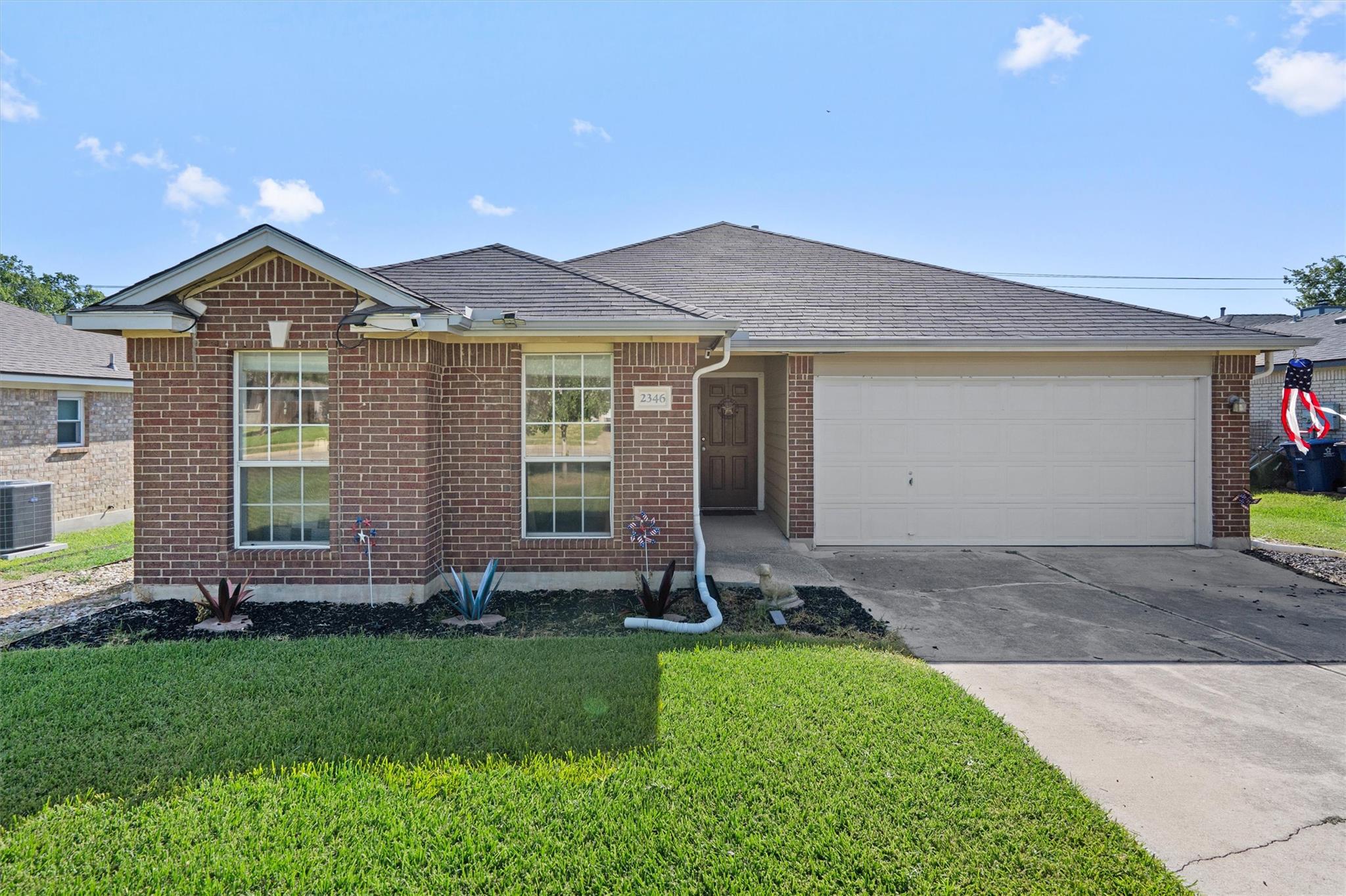 A classic brick exterior and well-maintained lawn