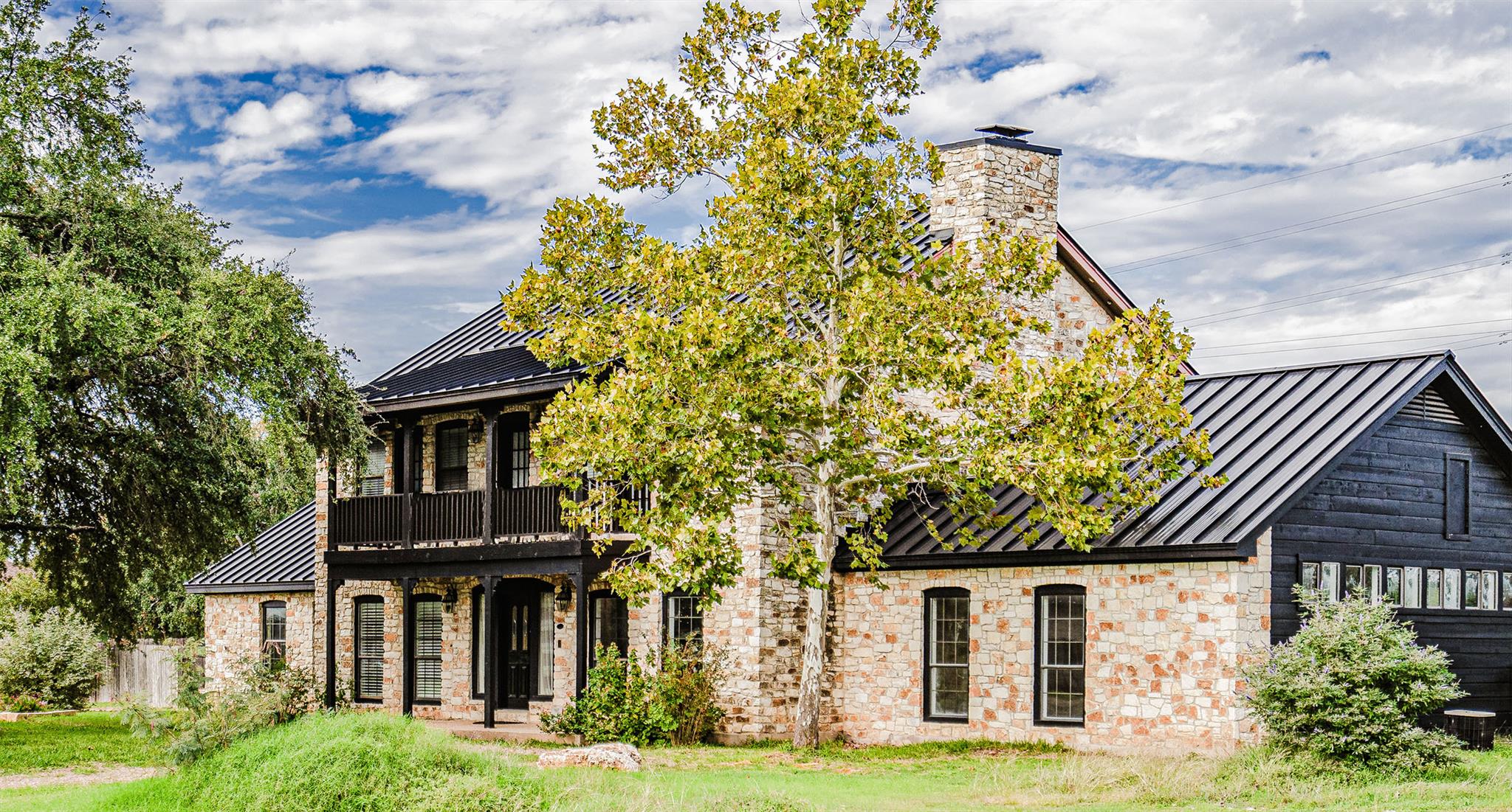 A striking exterior combines stone and dark wood 