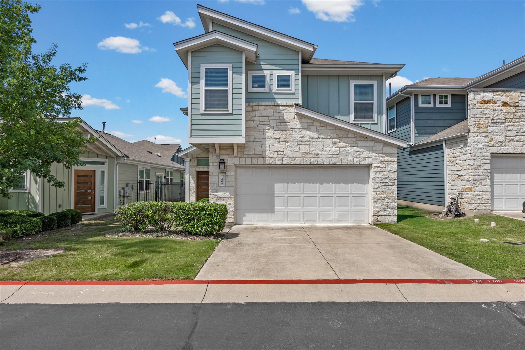 Modern townhome boasts stone and siding, a front 