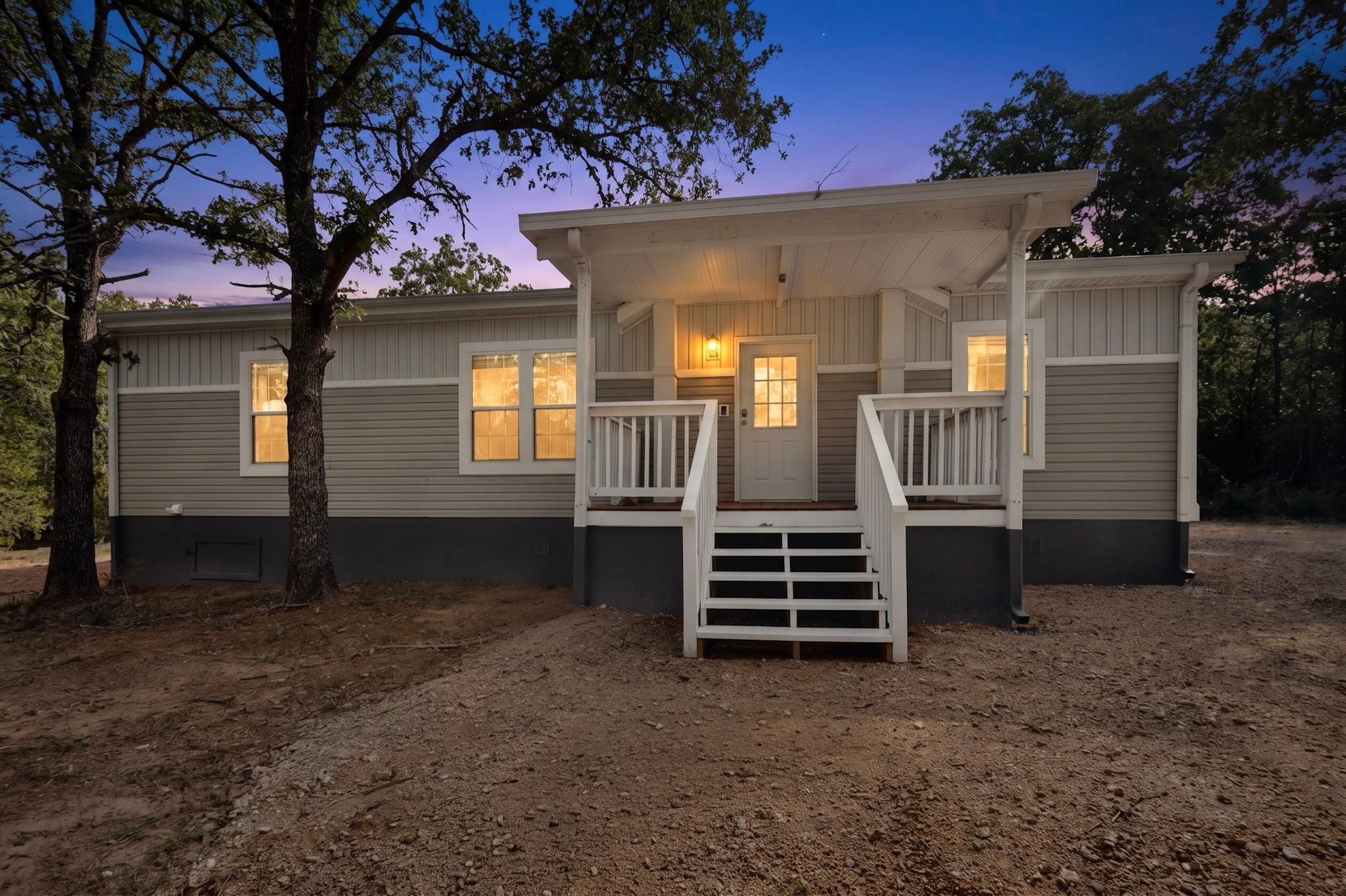 A welcoming front porch illuminates this charming