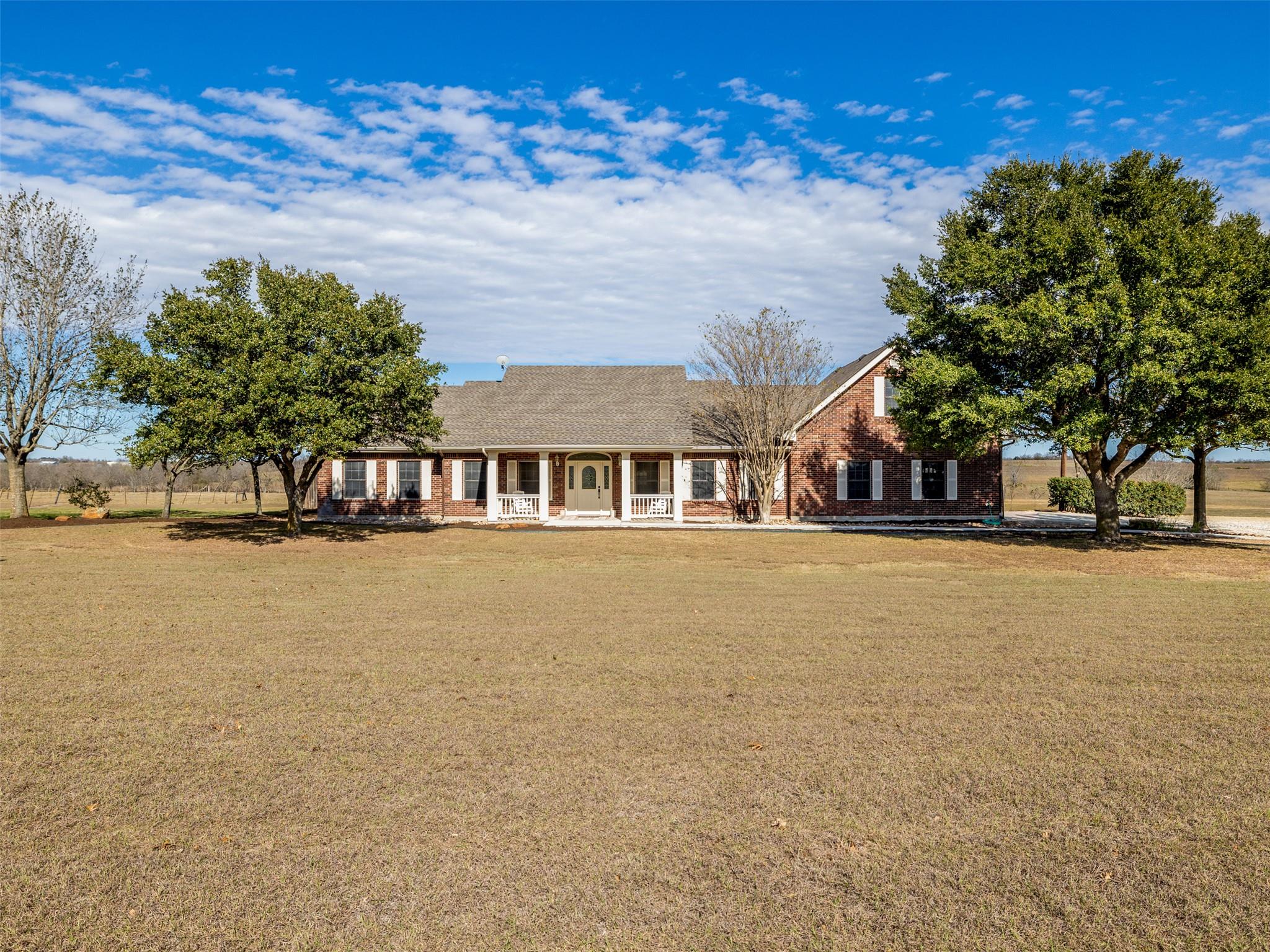 A spacious brick residence with a welcoming cover