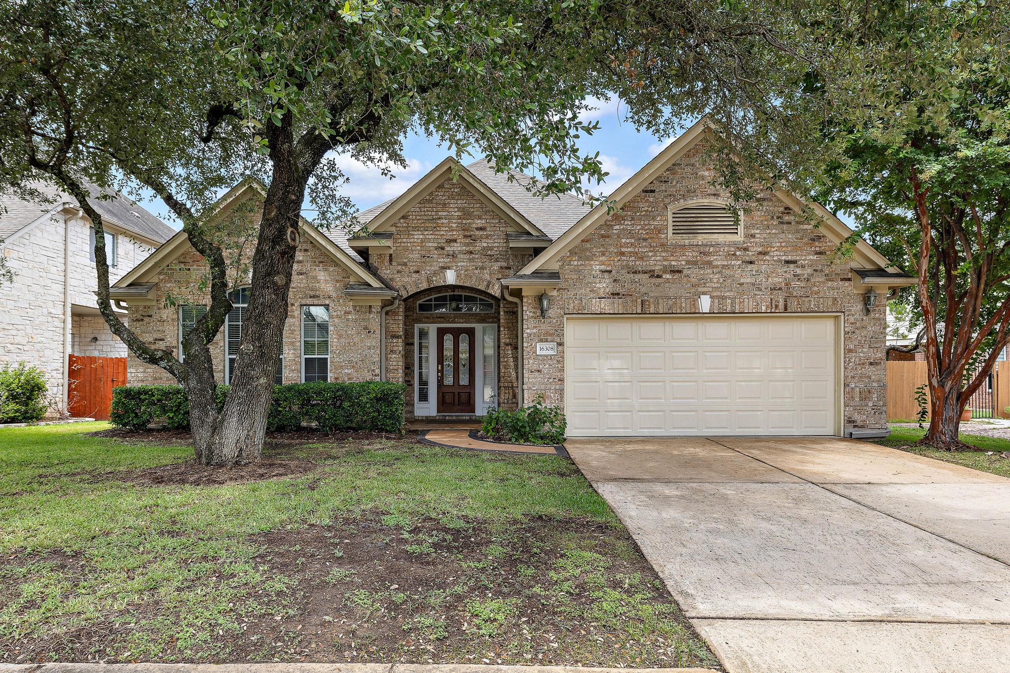 A classic brick facade welcomes you home, shaded 