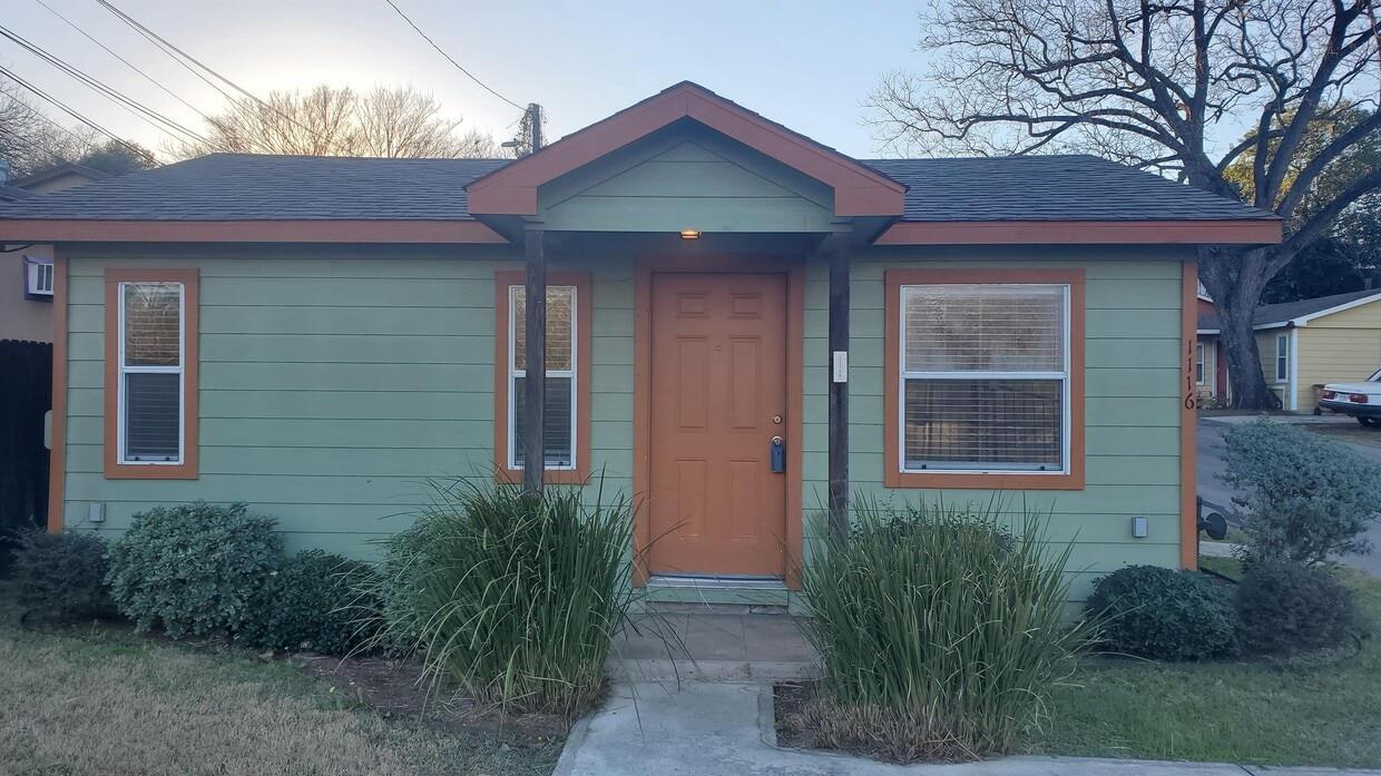 A welcoming front porch with a bold entry door co