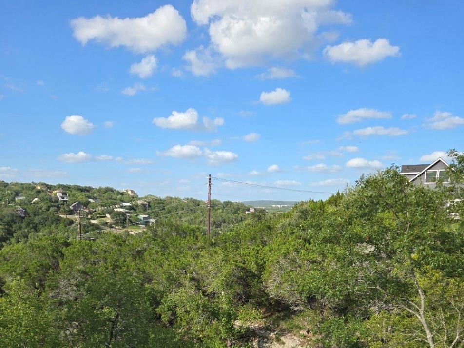 Perched above a tree-filled landscape, this prope