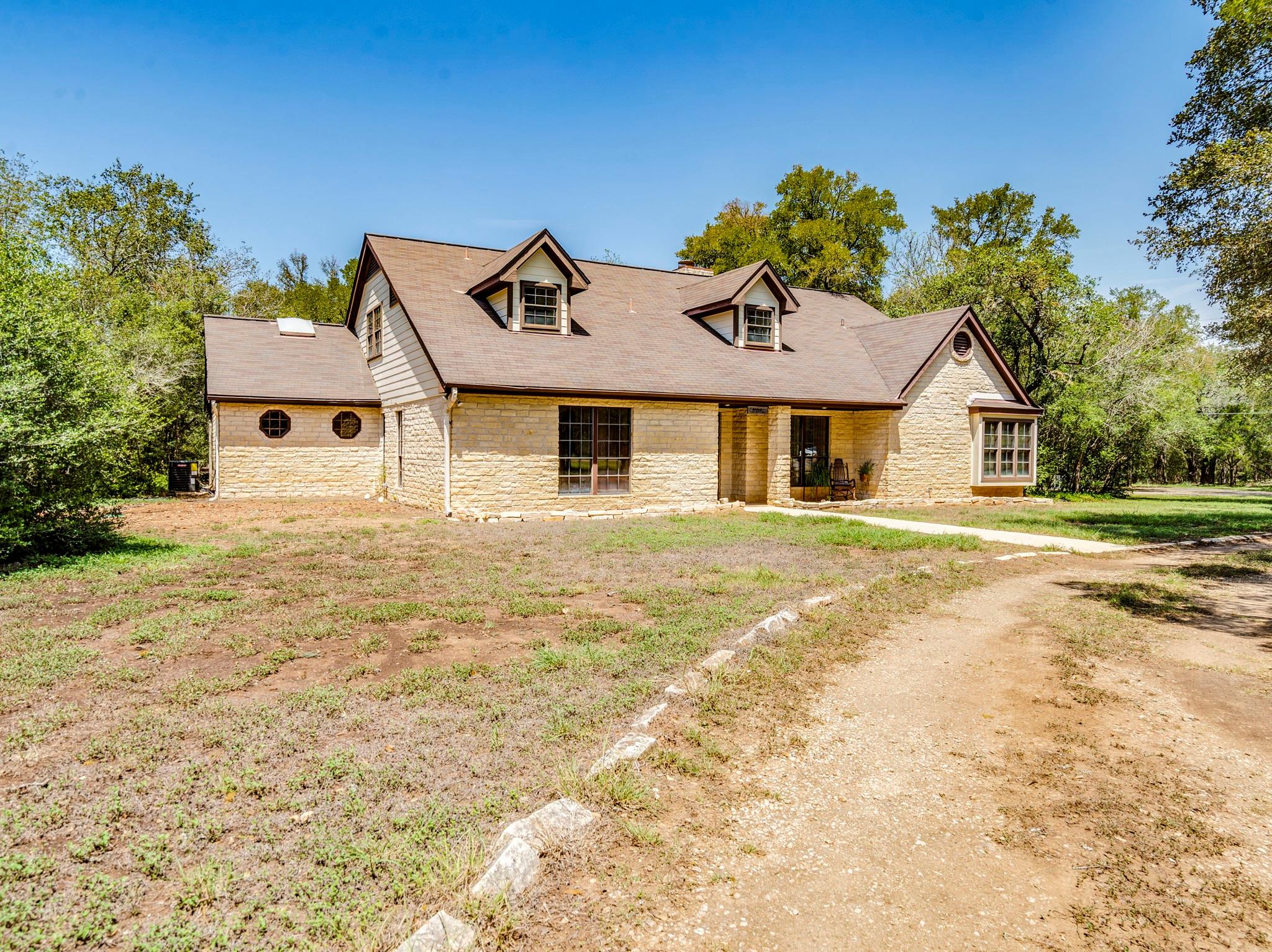 An inviting stone facade pairs with classic gable