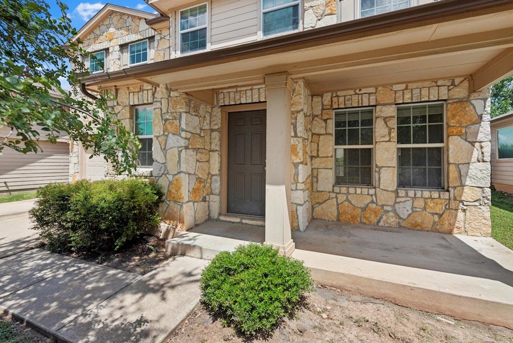 A welcoming stone facade with a covered porch off