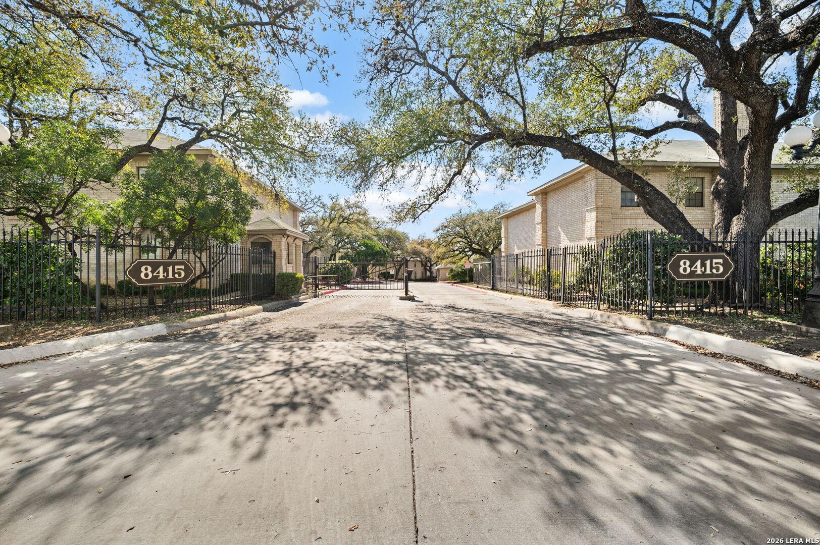 A private, gated community entrance framed by mat
