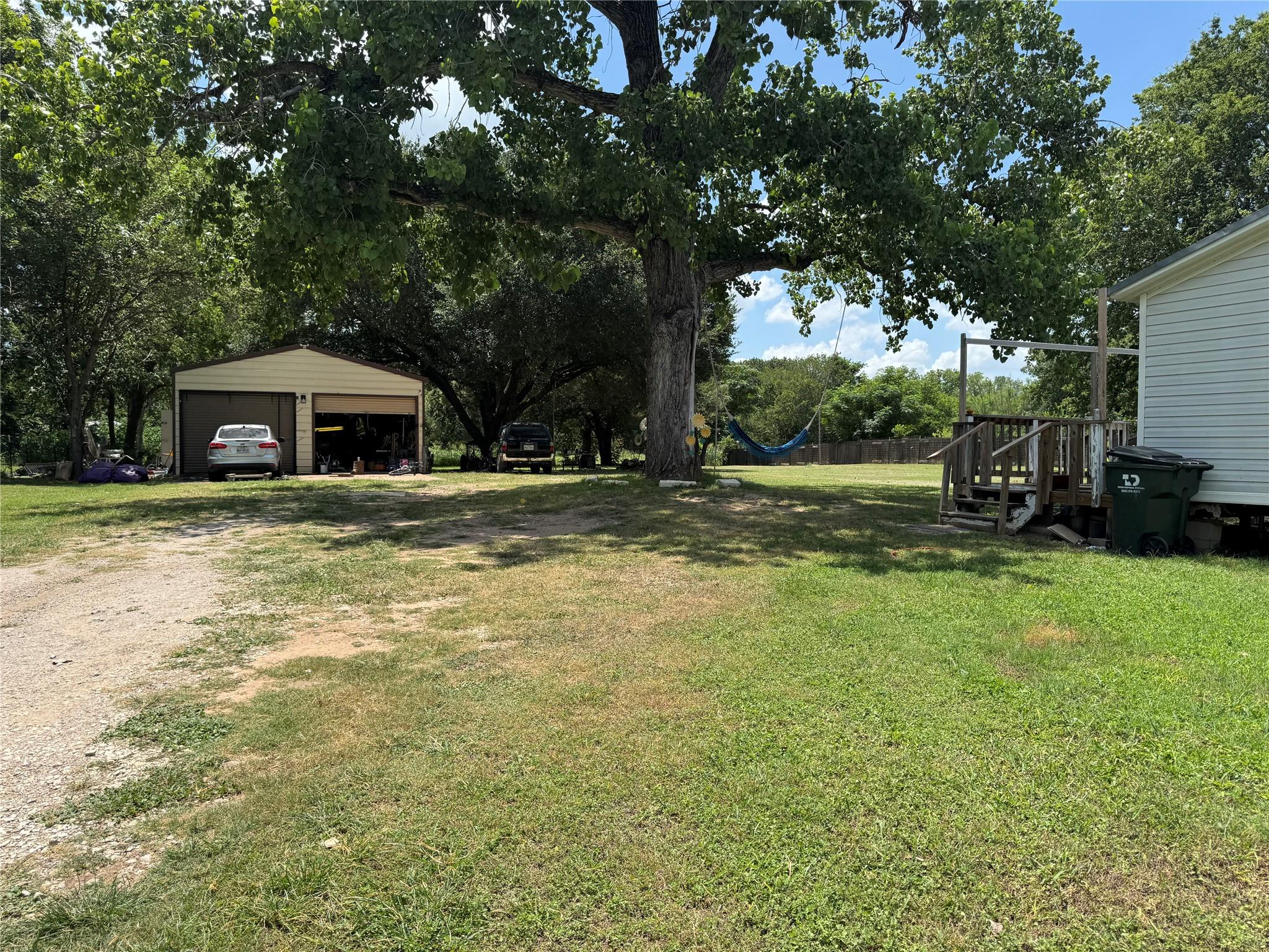 Mature trees shade a spacious yard with a detache