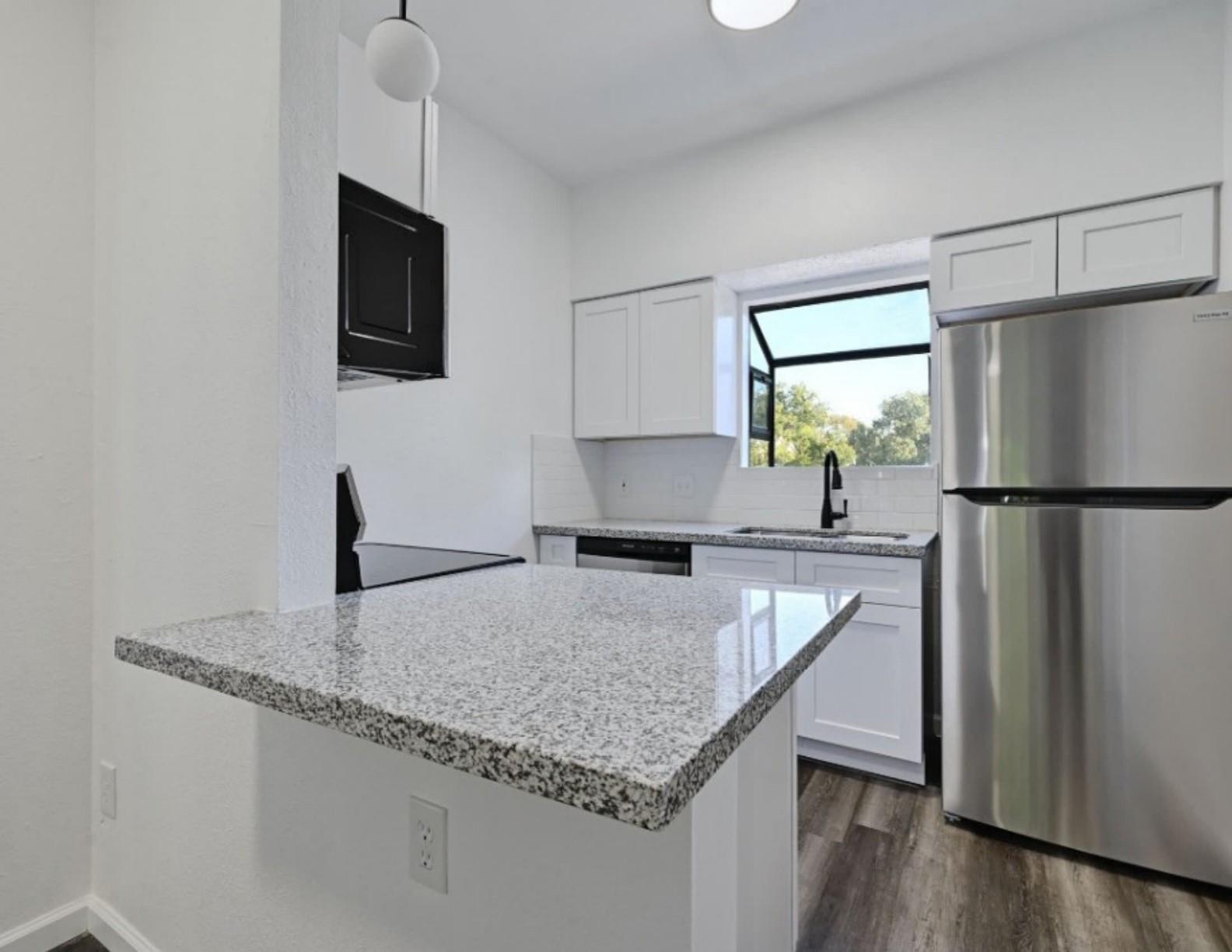 A well-appointed kitchen features ample counter s