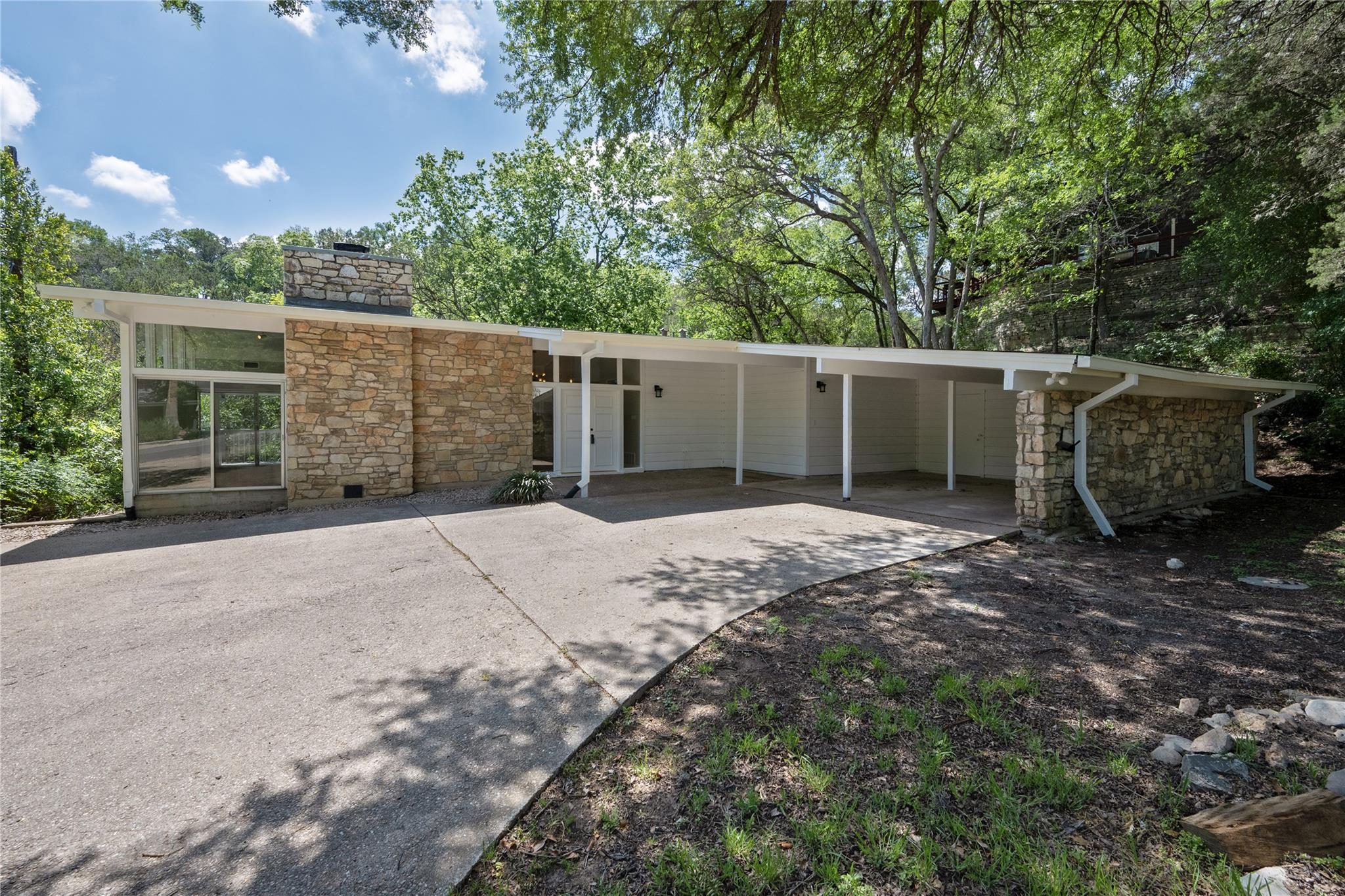 A striking mid-century modern home nestled in a l