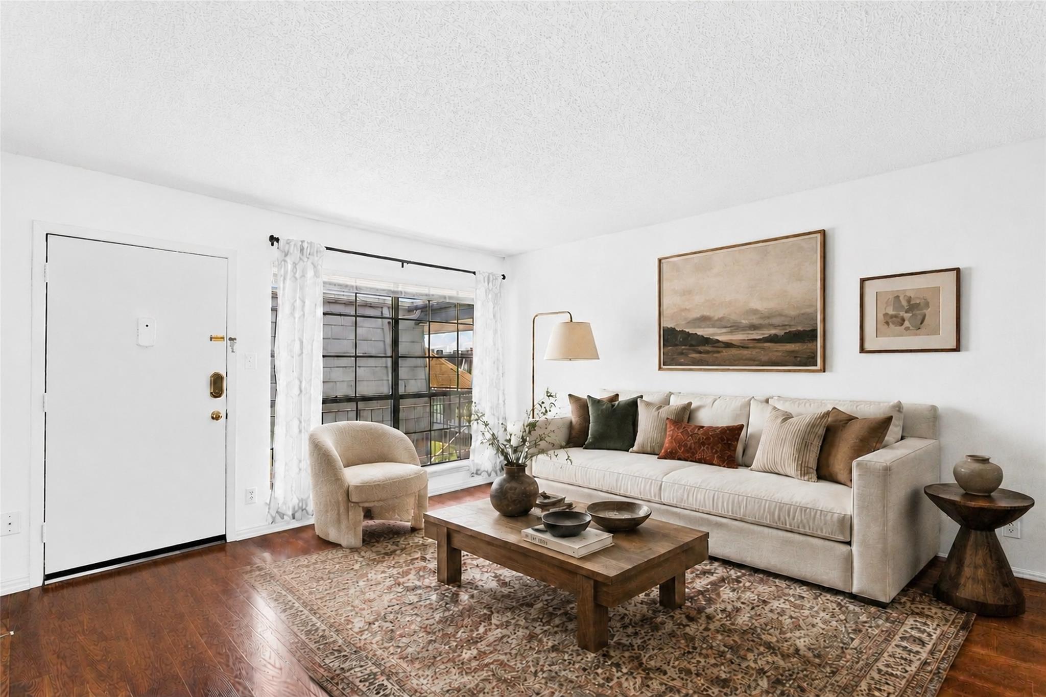 Hardwood floors and a large window illuminate thi