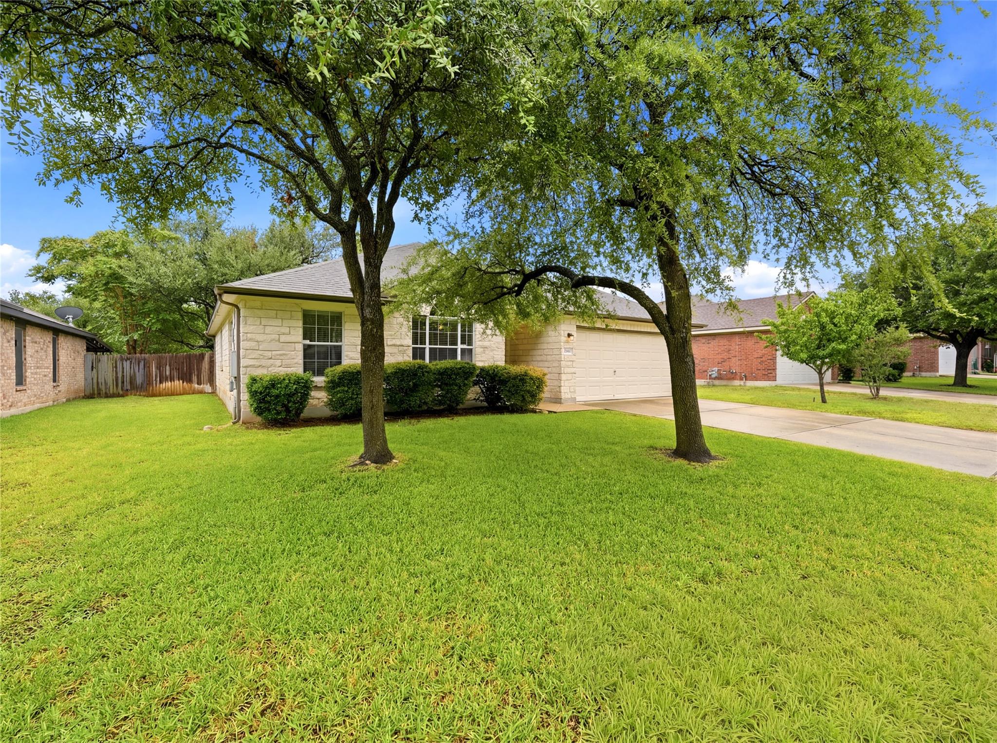 Mature trees shade the front yard of this charmin