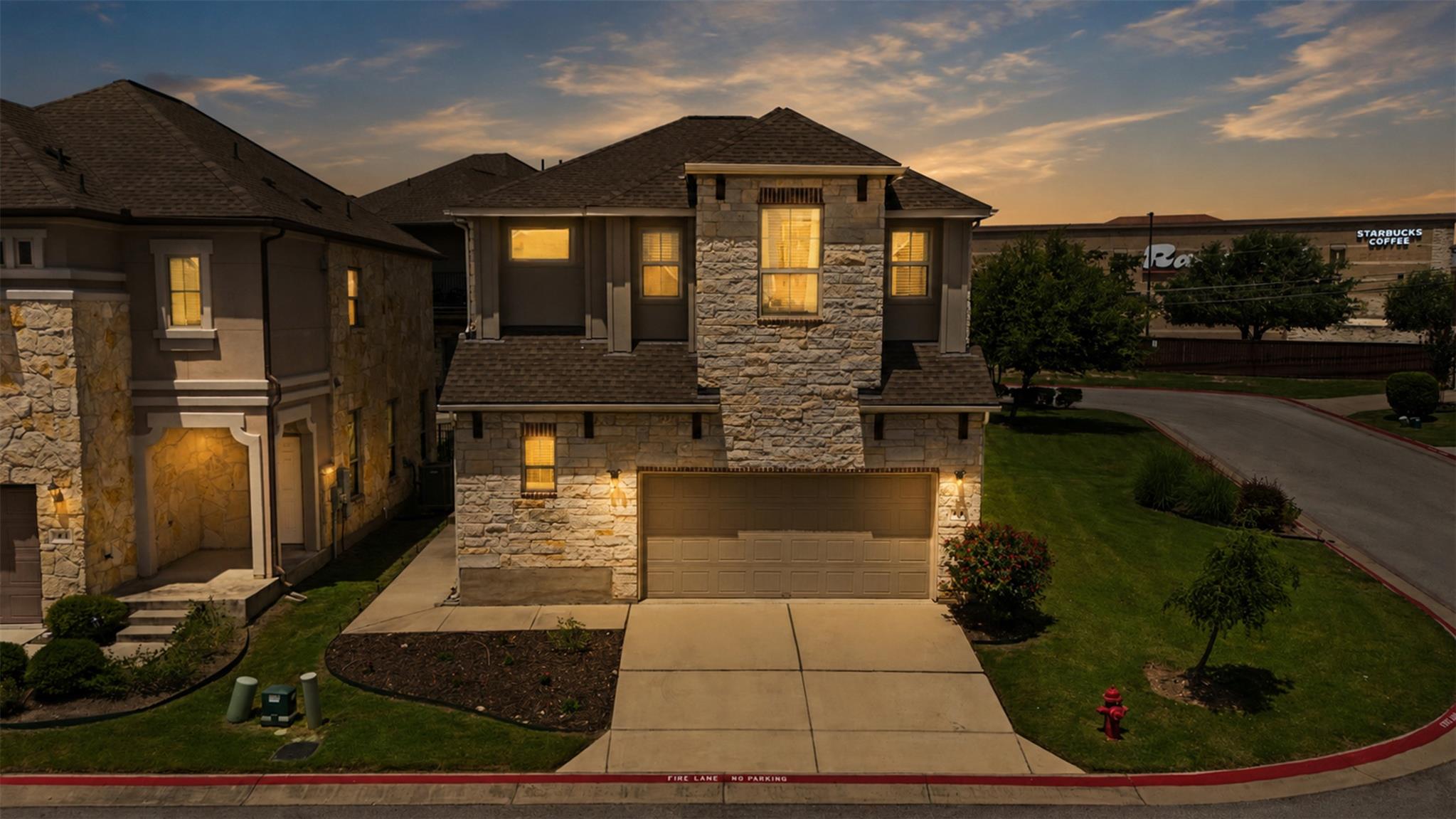Stone and stucco create an inviting facade, featu