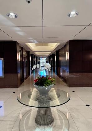 A well-lit hallway with polished floors leads to 