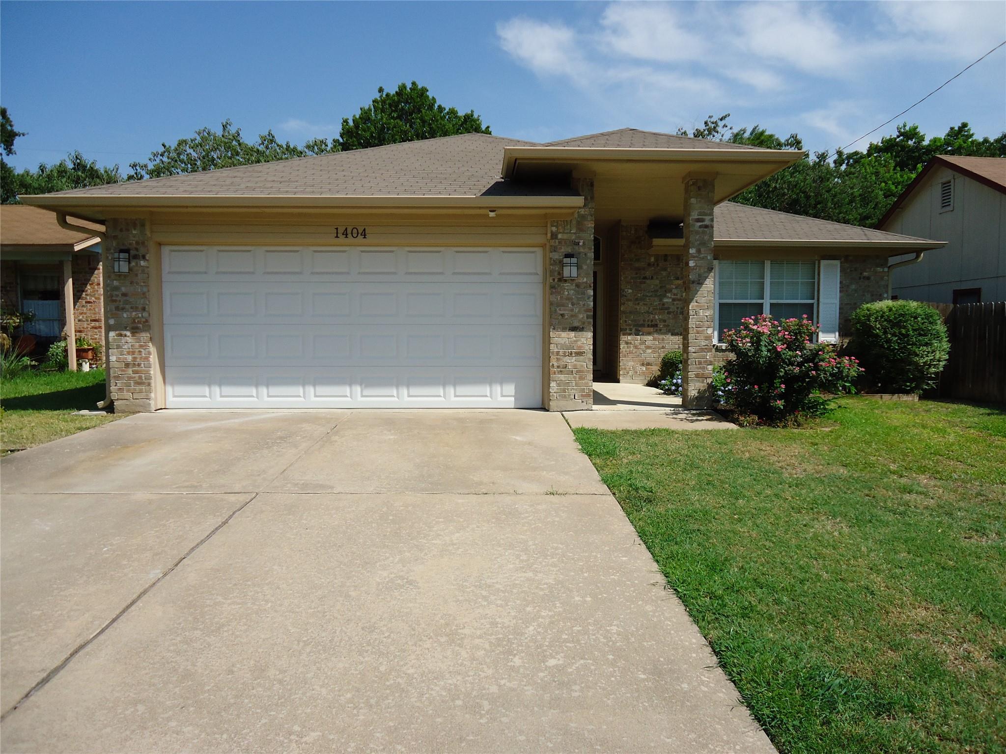 A well-maintained lawn and sturdy brick exterior 