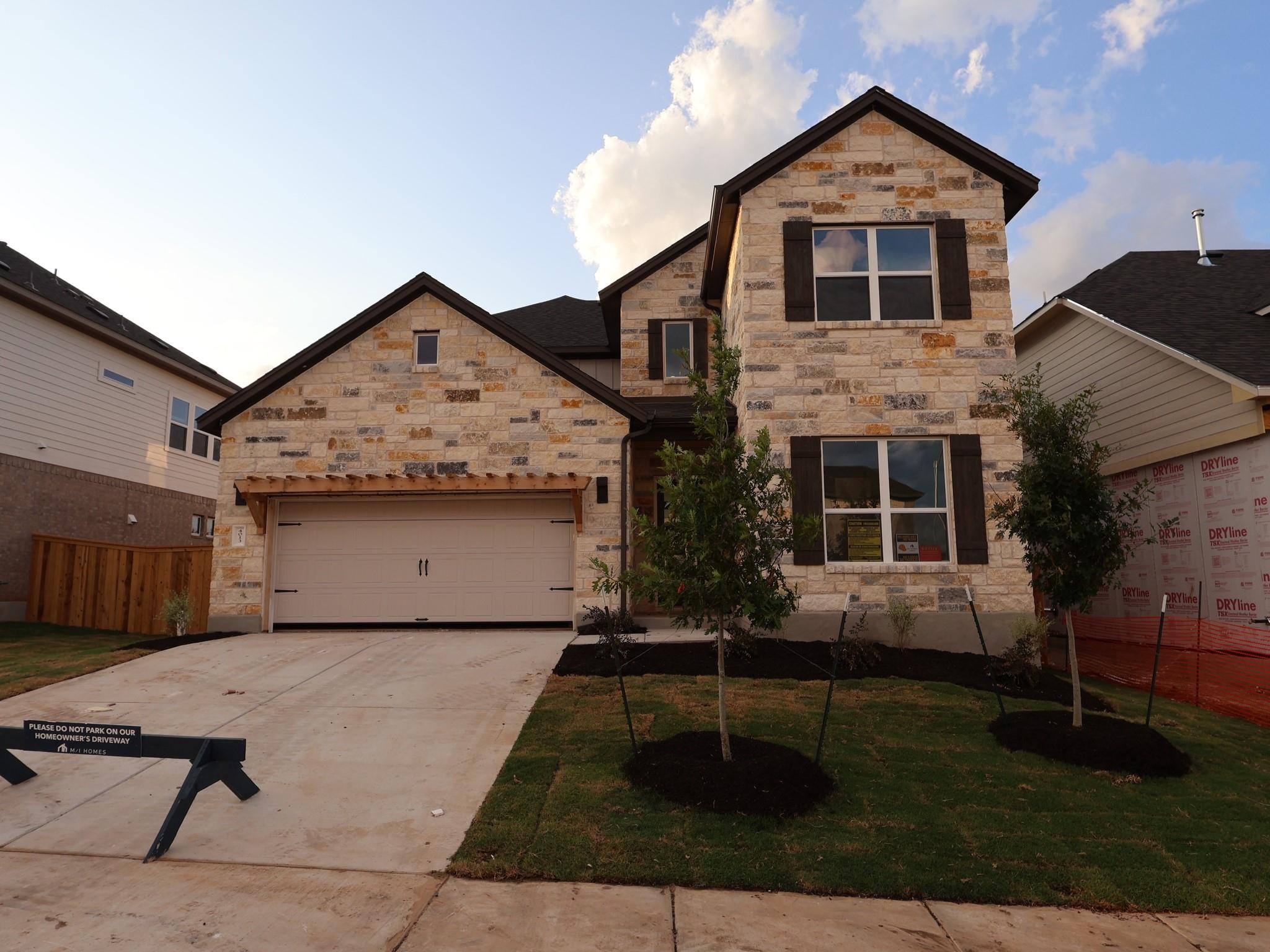 Textured stone veneer and prominent wood shutters