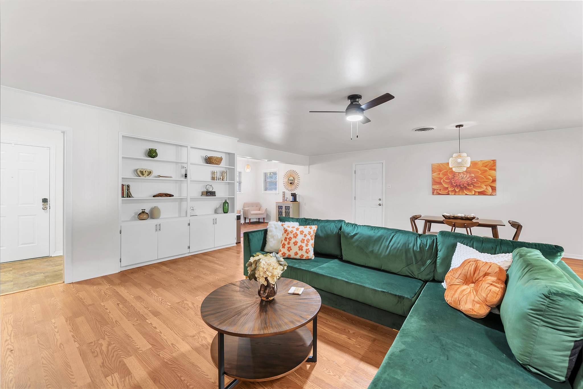 Blonde hardwood floors complement built-in shelvi