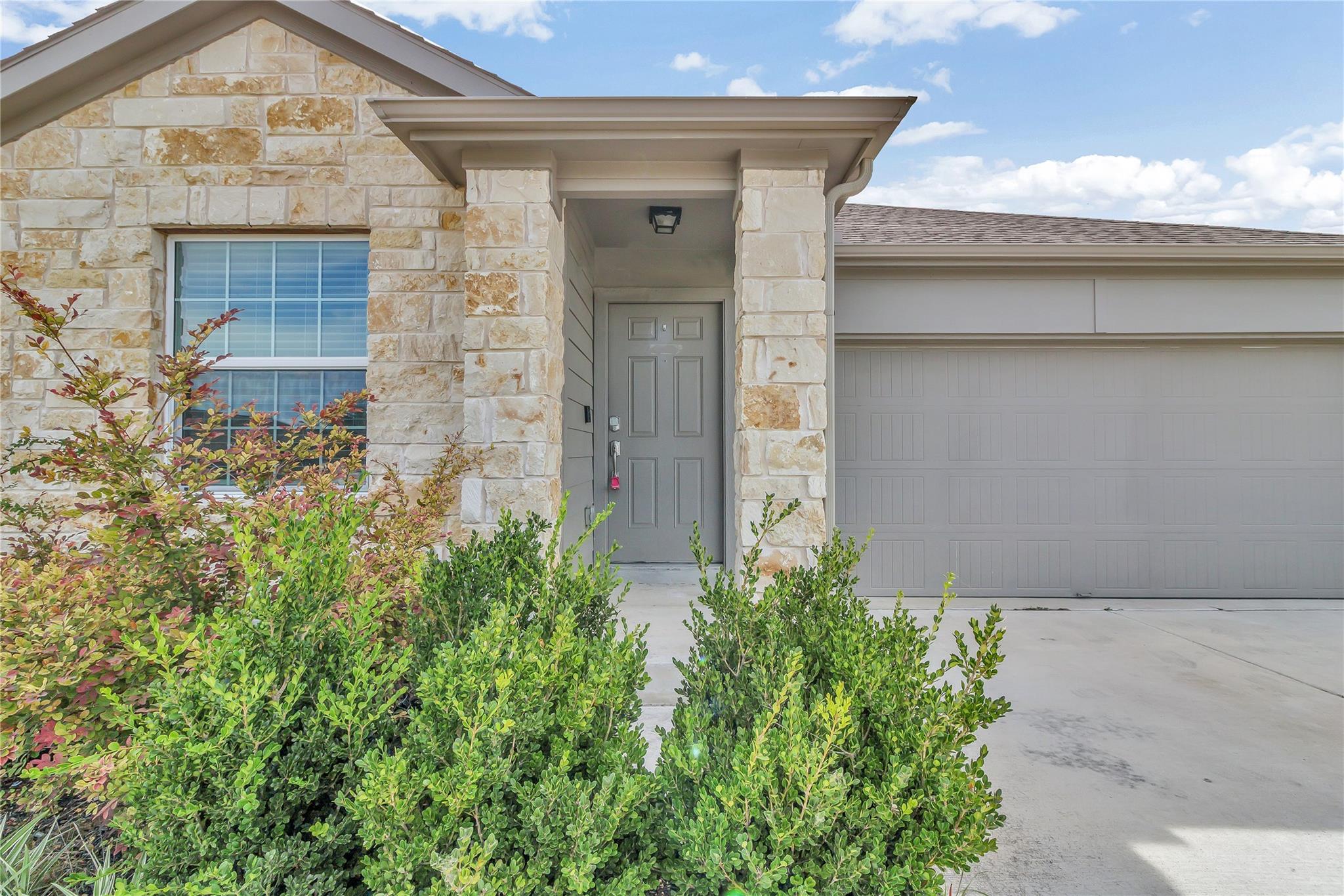 A welcoming stone facade with a covered entry and