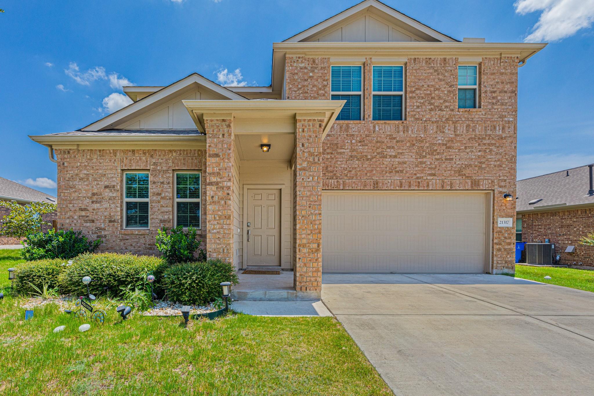A classic brick facade welcomes you home, complem