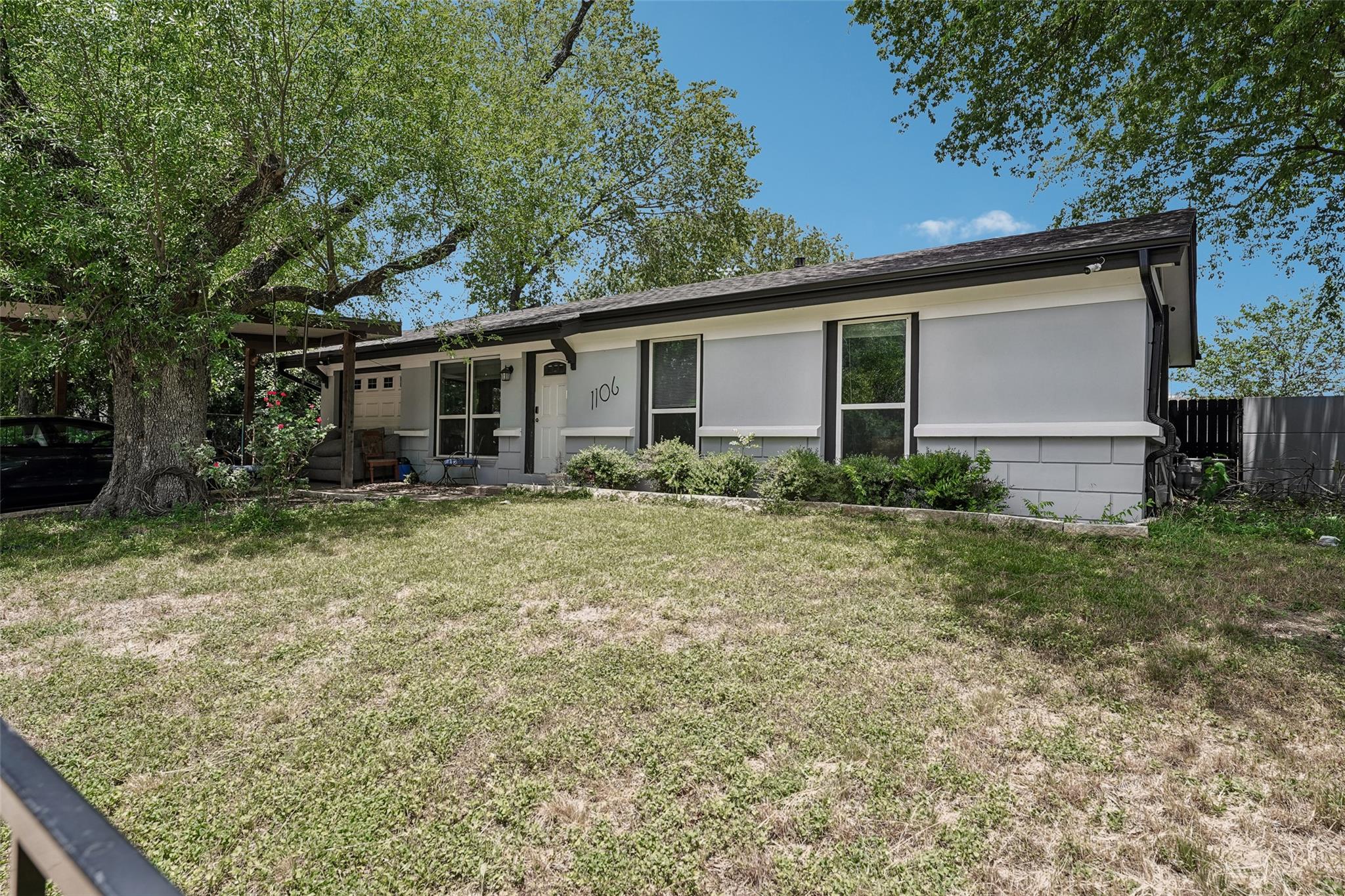 Mature trees canopy this inviting single-story re