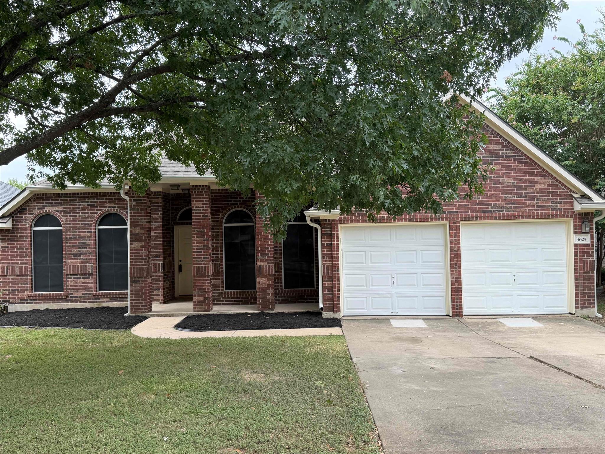 A classic brick facade with a two-car garage and 