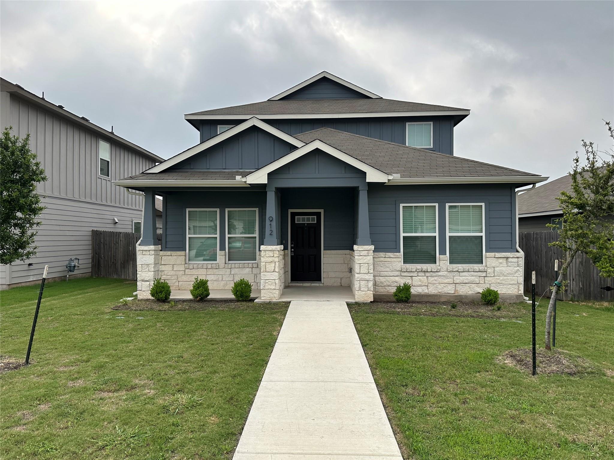Craftsman-style home featuring roof with shingles