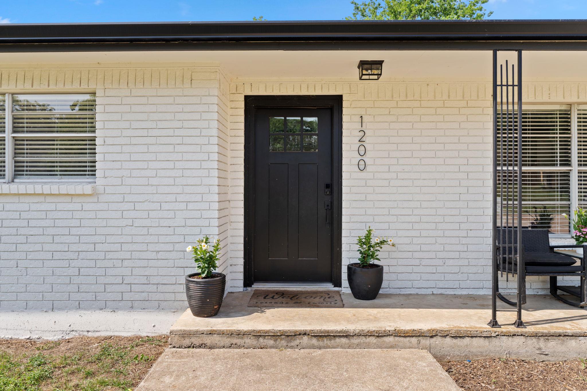 A classic brick facade with a prominent black doo