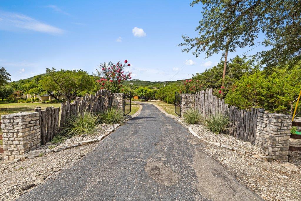 A private driveway entrance with rustic fencing a