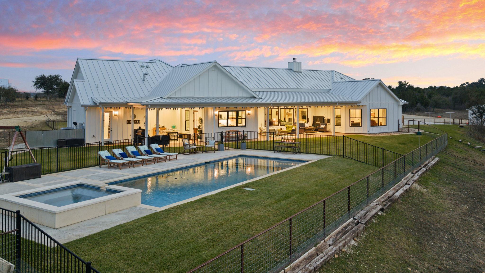 An inviting pool and spa beckon from the spacious