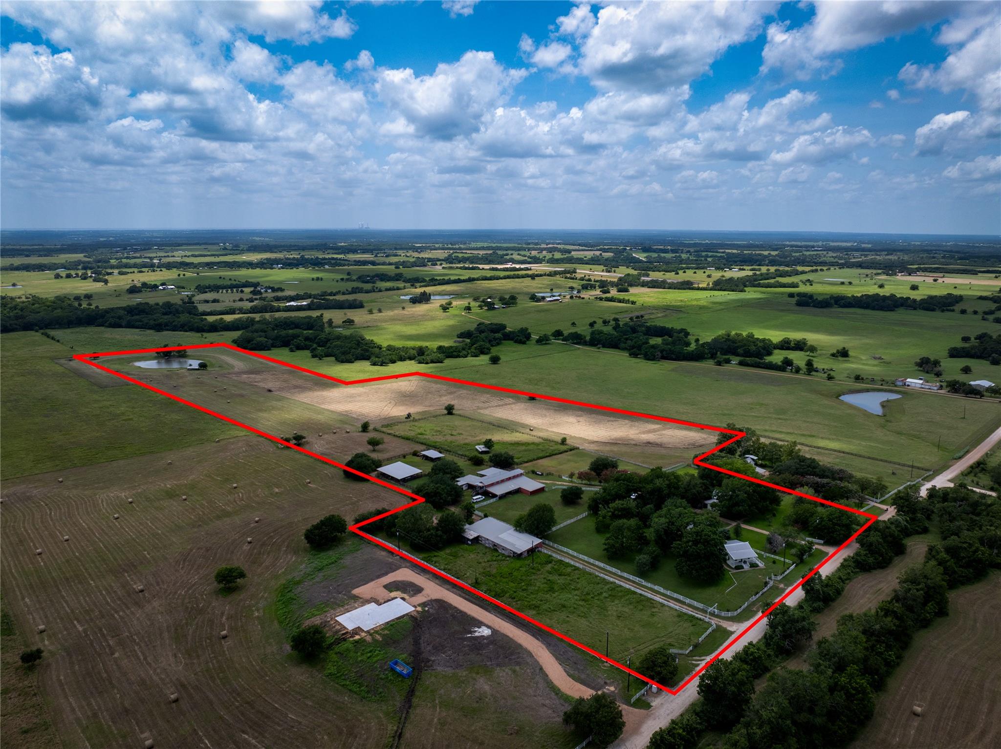 Rolling green acreage with multiple structures, p
