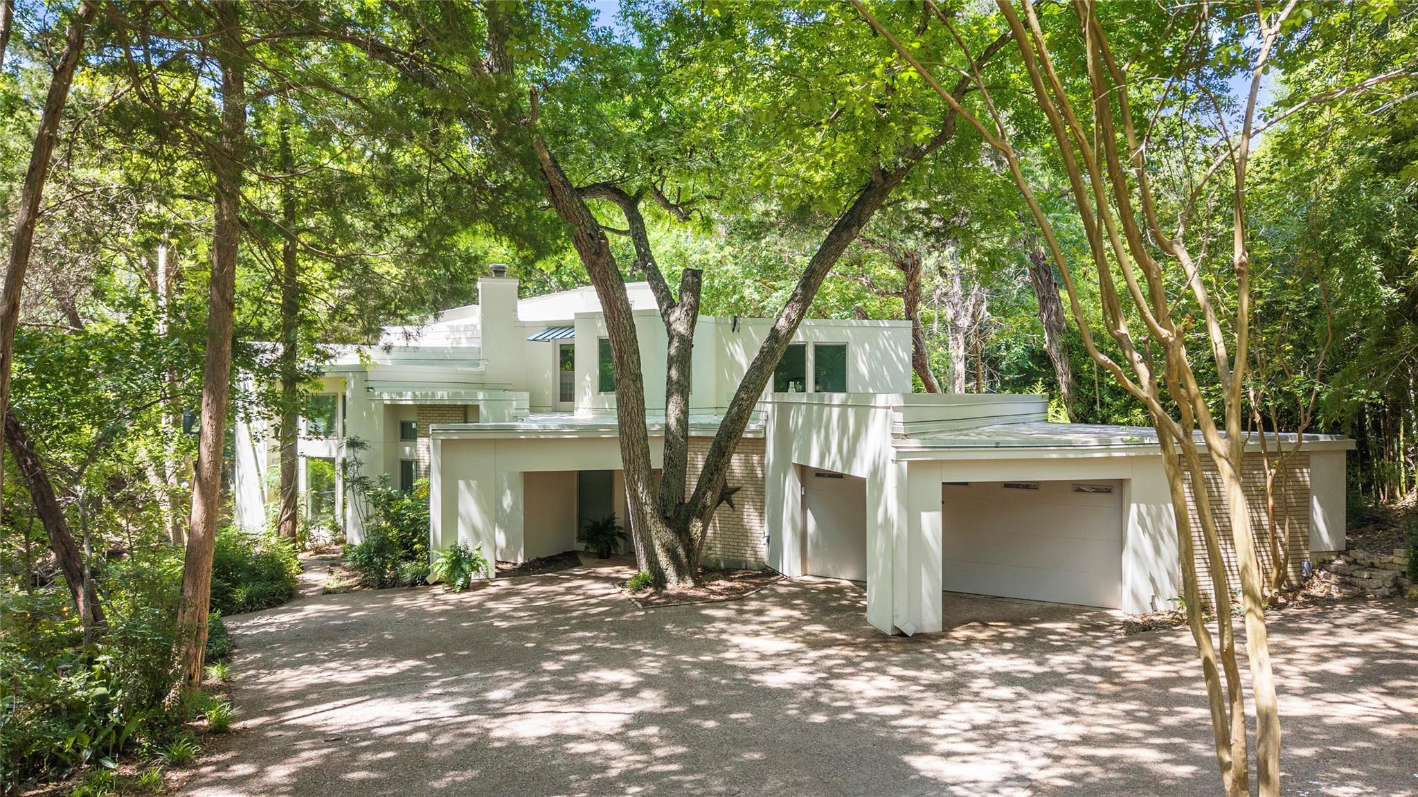 A secluded dwelling nestled among mature trees, b