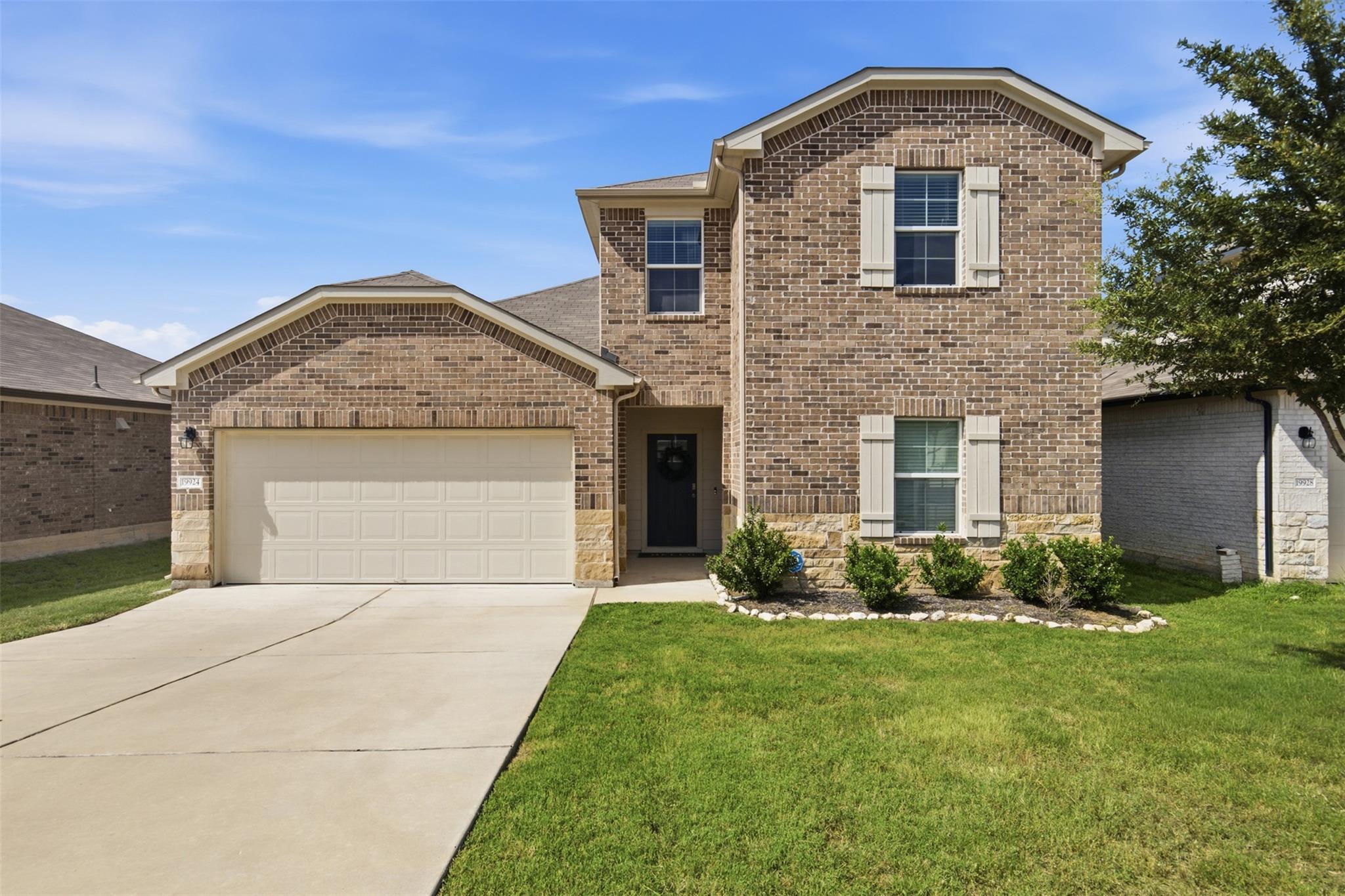 A classic brick facade welcomes you home with a n