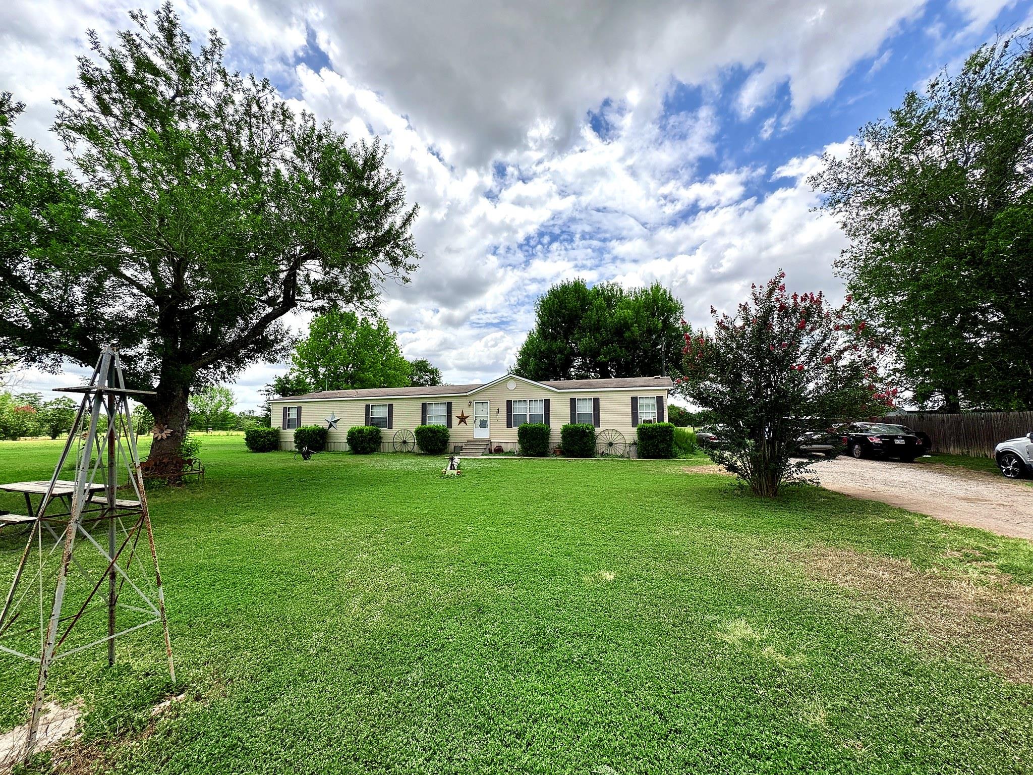A well-maintained manufactured home sits amidst a