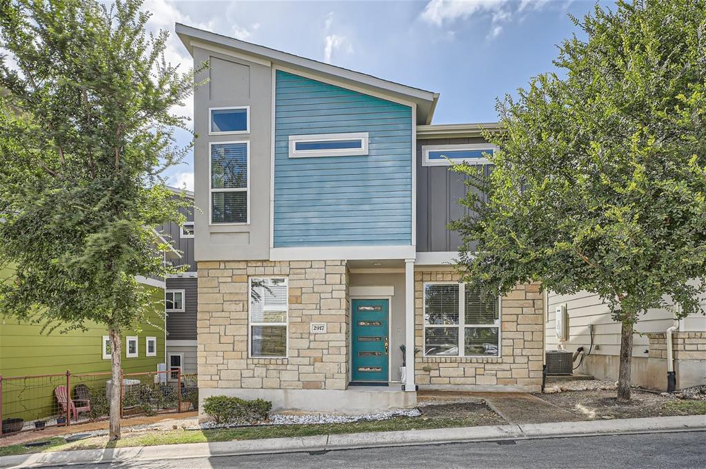 Bold stone and varied siding finishes define this
