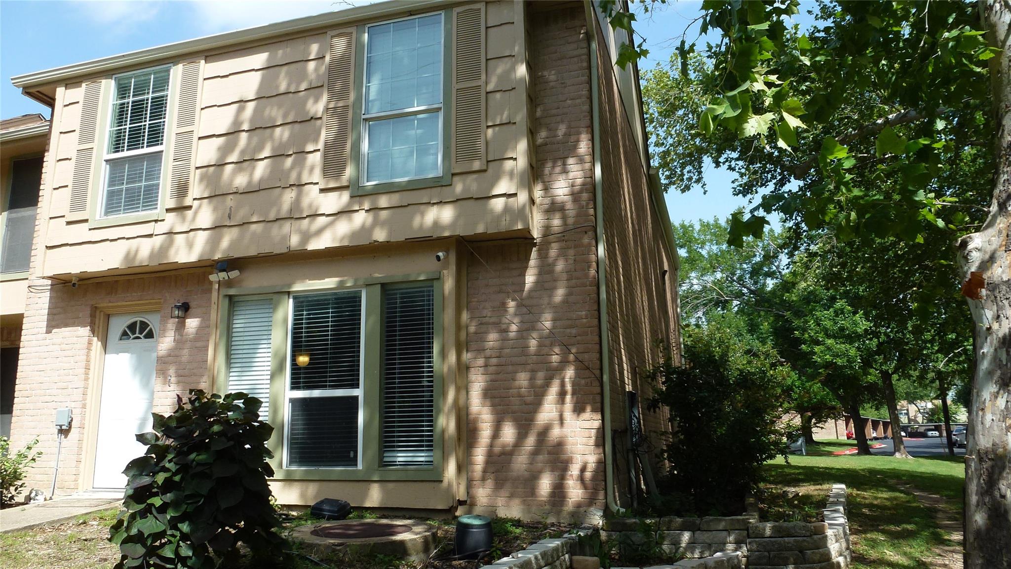 A charming two-story home with a partial brick fa