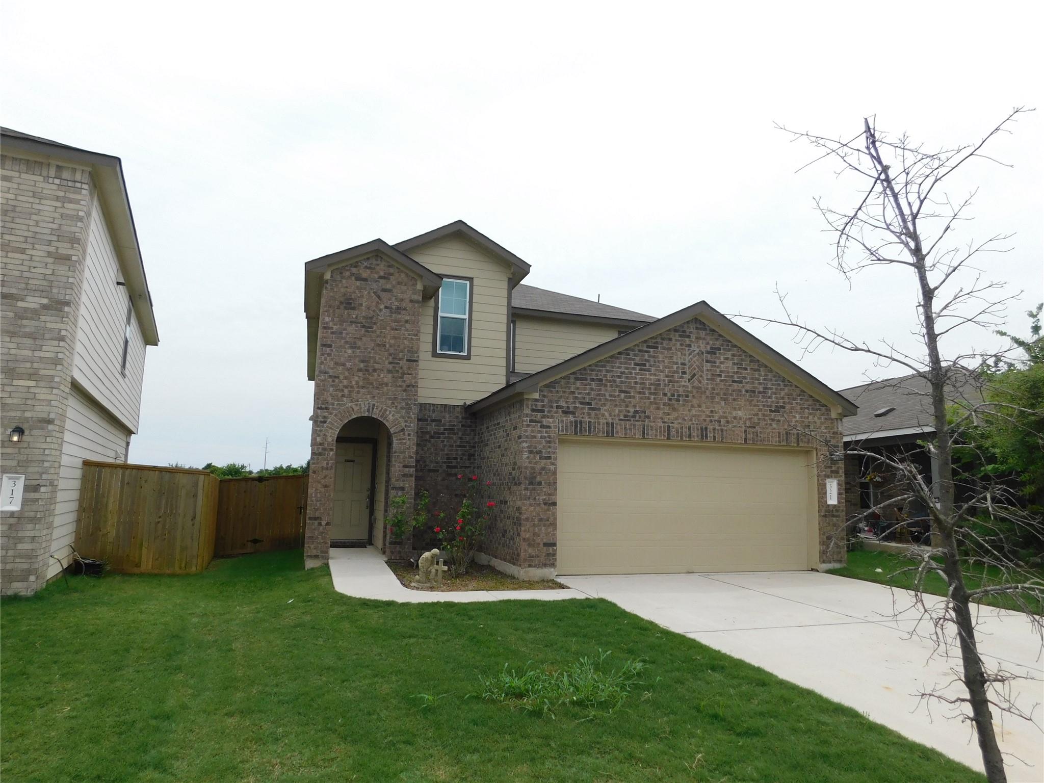 A classic brick and siding residence with an atta